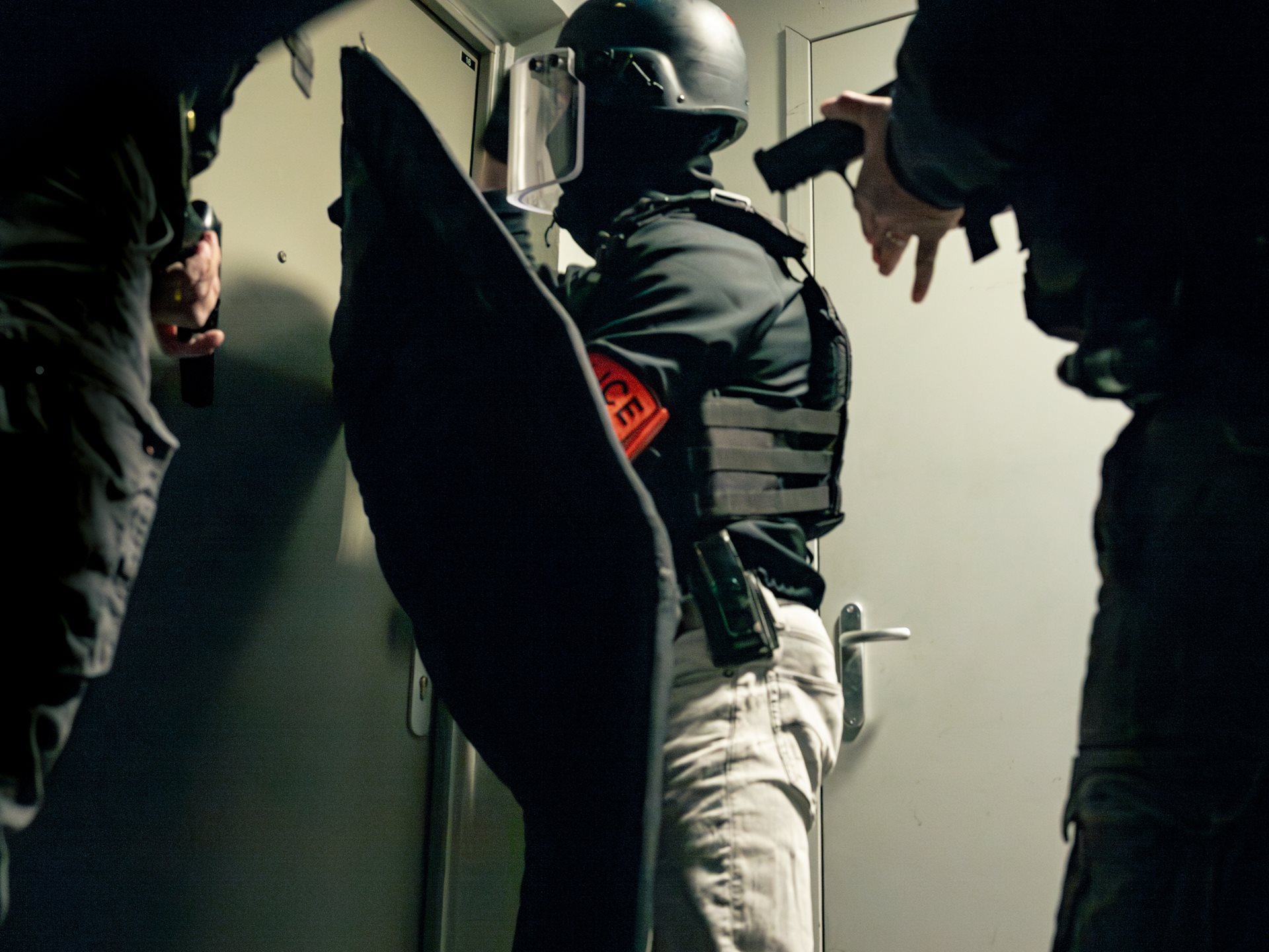 Officers of the anti-crime brigade (BAC) prepare to raid a suspected drug dealer's home at 6 a.m. in Seine-Saint-Denis, France.