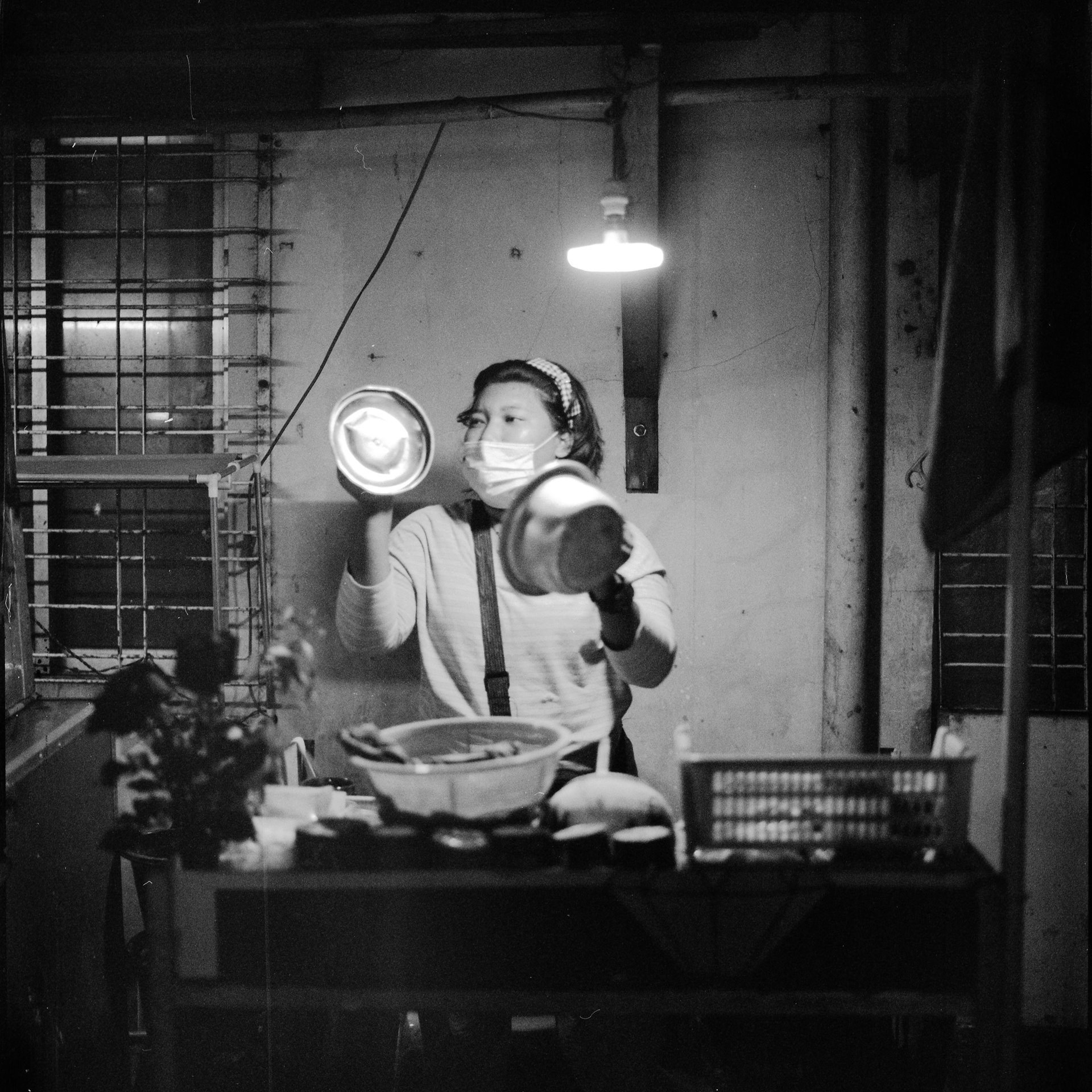 A street vendor bangs pots at 8:00 p.m., in Yangon, Myanmar, a form of protest that spread across the country.