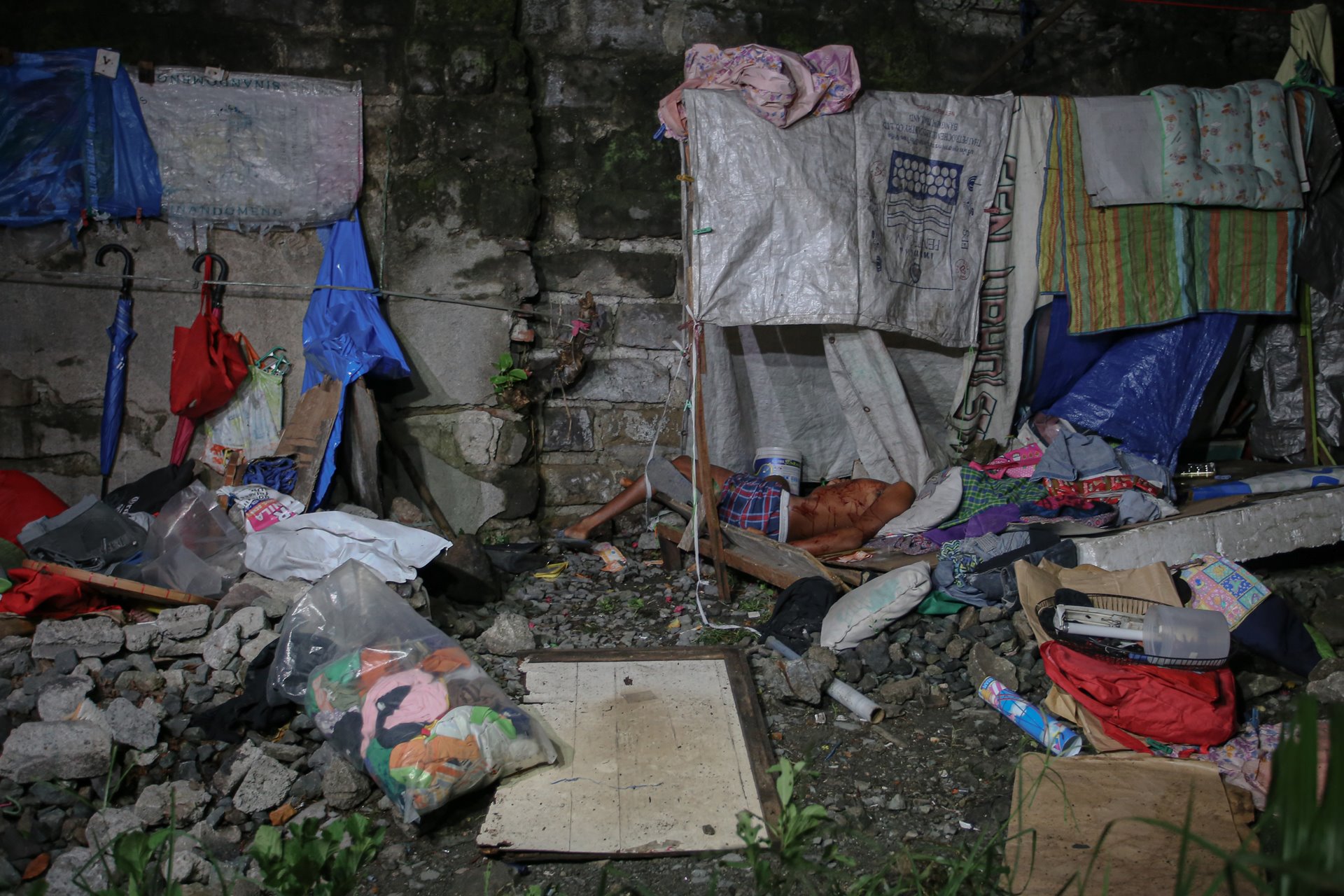 The dead body of an unidentified man lies on a make-shift dwelling beside a rail track in Pandacan, Manila, the Philippines, following a police anti-drug operation. Police said the man was a drug-pusher they were investigating, and that they were forced to shoot him in self-defense.