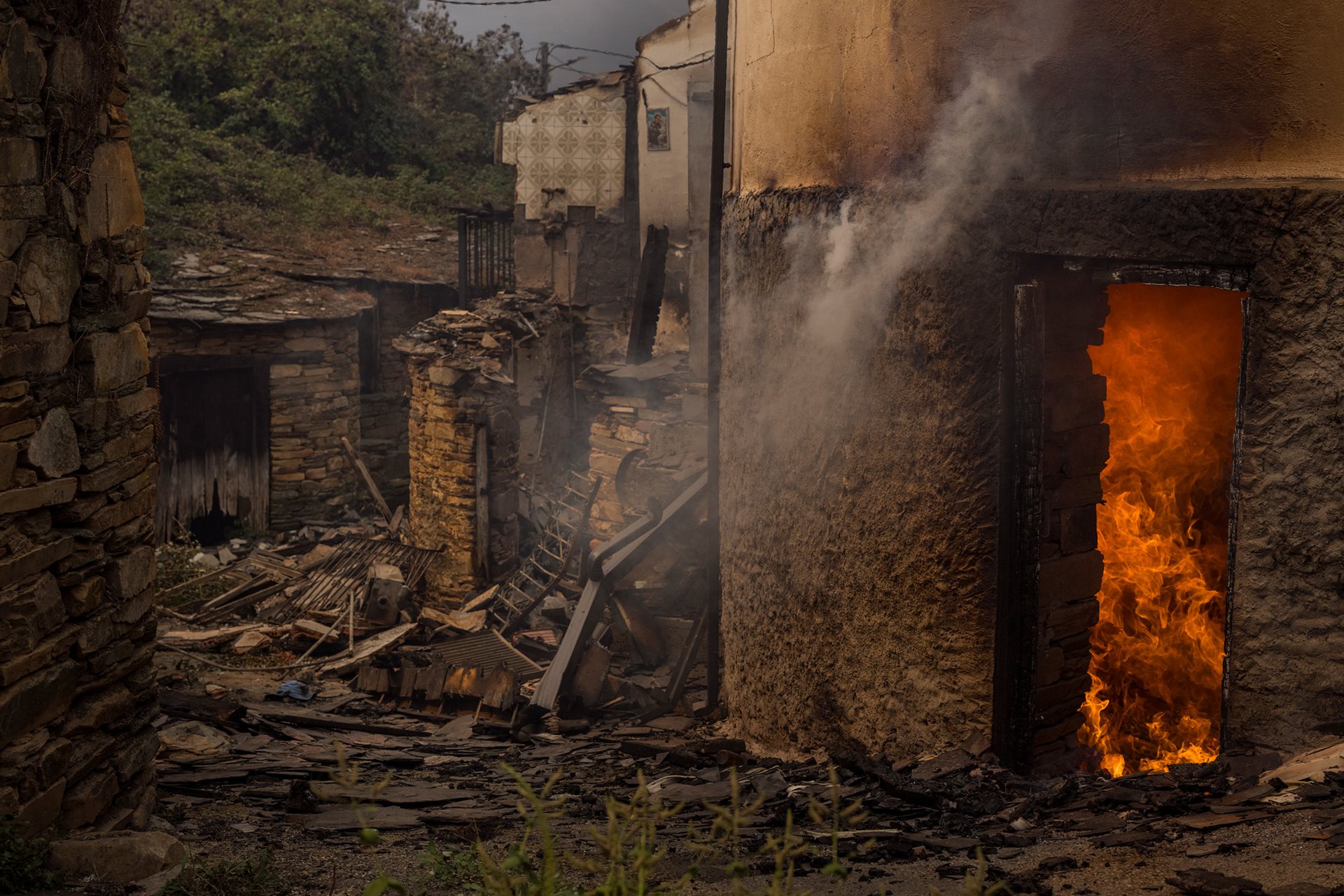 The interior of a house burns in the village of San Vicente de Leira, Ourense, Galicia, Spain. Two days after the wildfire broke out, the house was still burning.