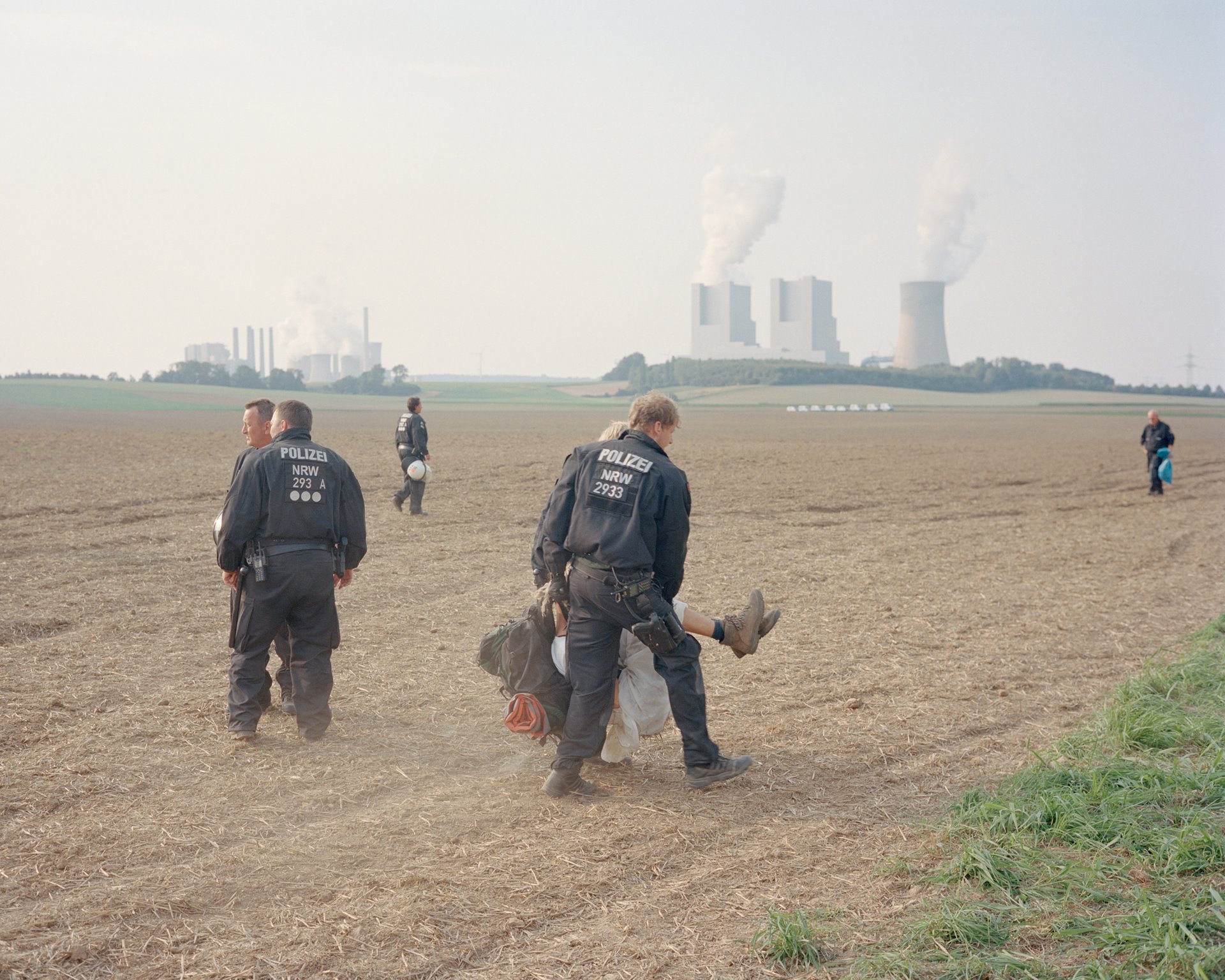 Police officers in Bedburg, Germany, carry away a demonstrator after surrounding hundreds of activists in a field beside railroad tracks leading to the Neurath coal-fired power plant.