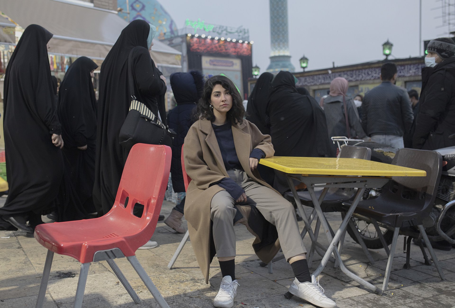 <p>An Iranian woman sits on a chair in front of a busy square in Tehran, defying the mandatory hijab law. &ldquo;A few days after Mahsa&rsquo;s death, I was walking past Keshavarz Boulevard when I saw a massive crowd of men and women, young and old, chanting a slogan that I&rsquo;ve never heard before: &lsquo;Woman, Life, Freedom&rsquo;. It enlightened me, it was moving,&rdquo; she said.</p>
