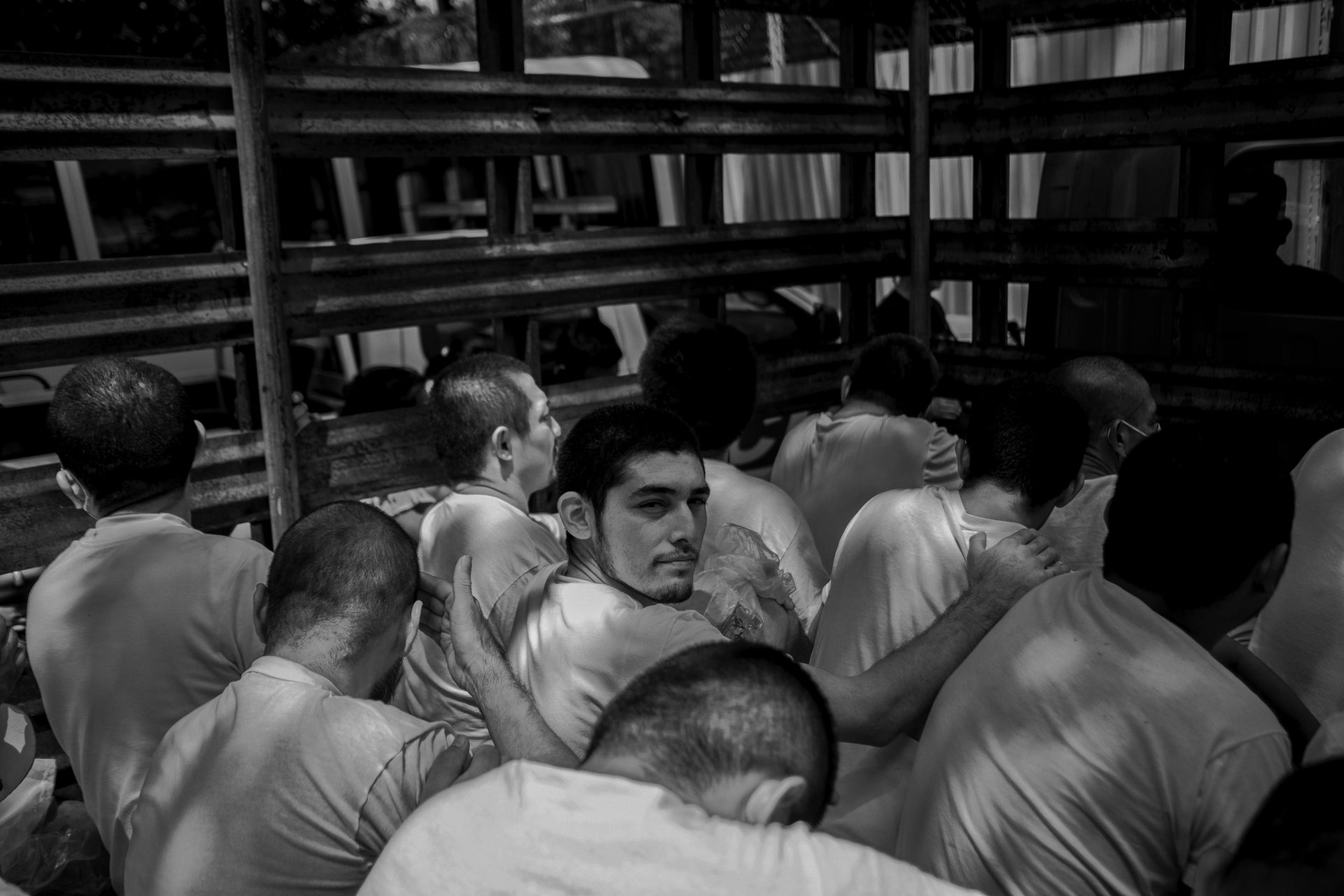A group of arrested people awaits entrance to Ilopango jail. Many would spend over a year behind bars without due process. Trials are conducted in groups rather than on a case-by-case basis. Ilopango, San Salvador, El Salvador.