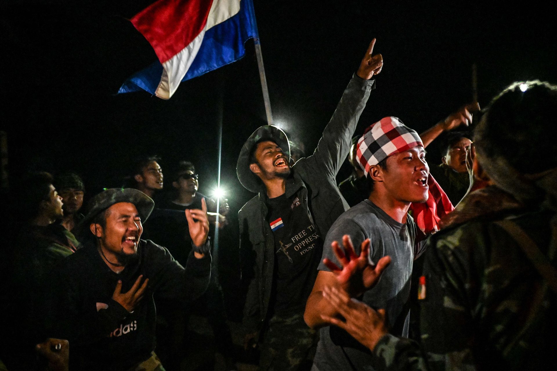 Khu Reedu (27, center), the commander of the Karenni Nationalities Defense Force, and fellow fighters celebrate victory over a junta military base near Shadaw, Kayah (Karenni) State, Myanmar. They had been trying for a month to push the military from two camps it had established on a hill above the town.&nbsp;