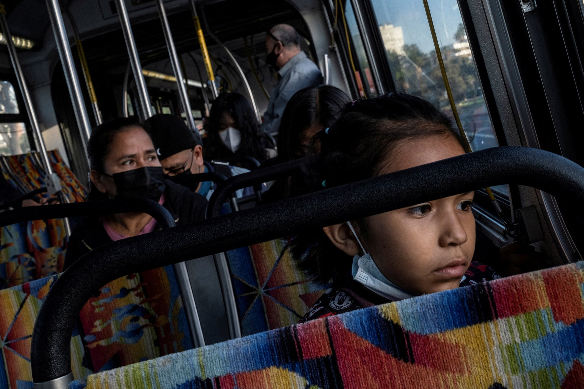 Maria Hernandez travels by bus with her daughters Nicole (foreground) and Michelle on the way to Nicole&rsquo;s school, in Los Angeles, California, United States.