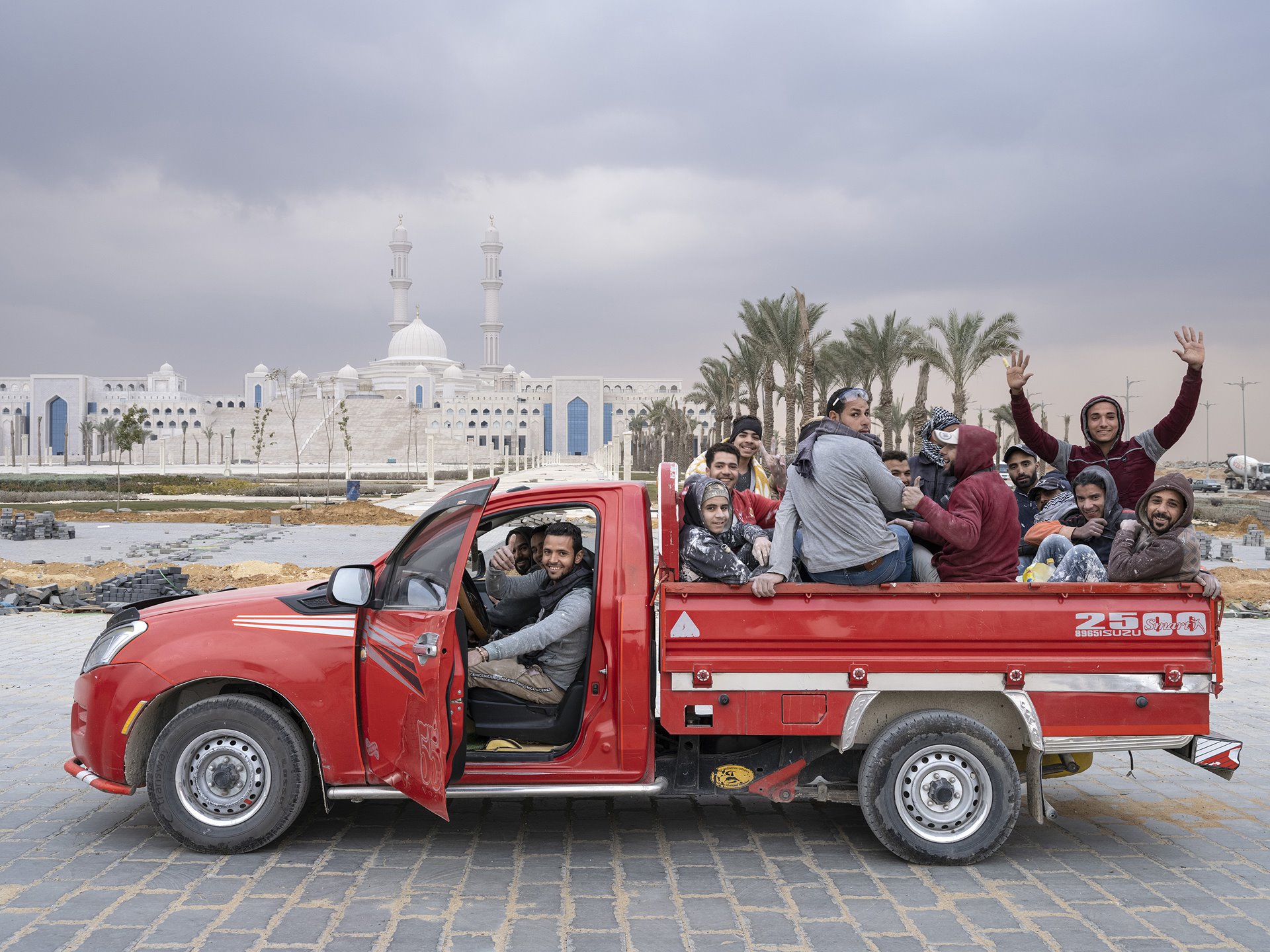 <p>Workers on their way home pass the newly built Misr Mosque in Egypt&#39;s New Administrative Capital, under construction near Cairo. The mosque, situated south of Government District, will be one of the largest in the world, with a capacity to accommodate more than 100,000 worshippers.</p>
