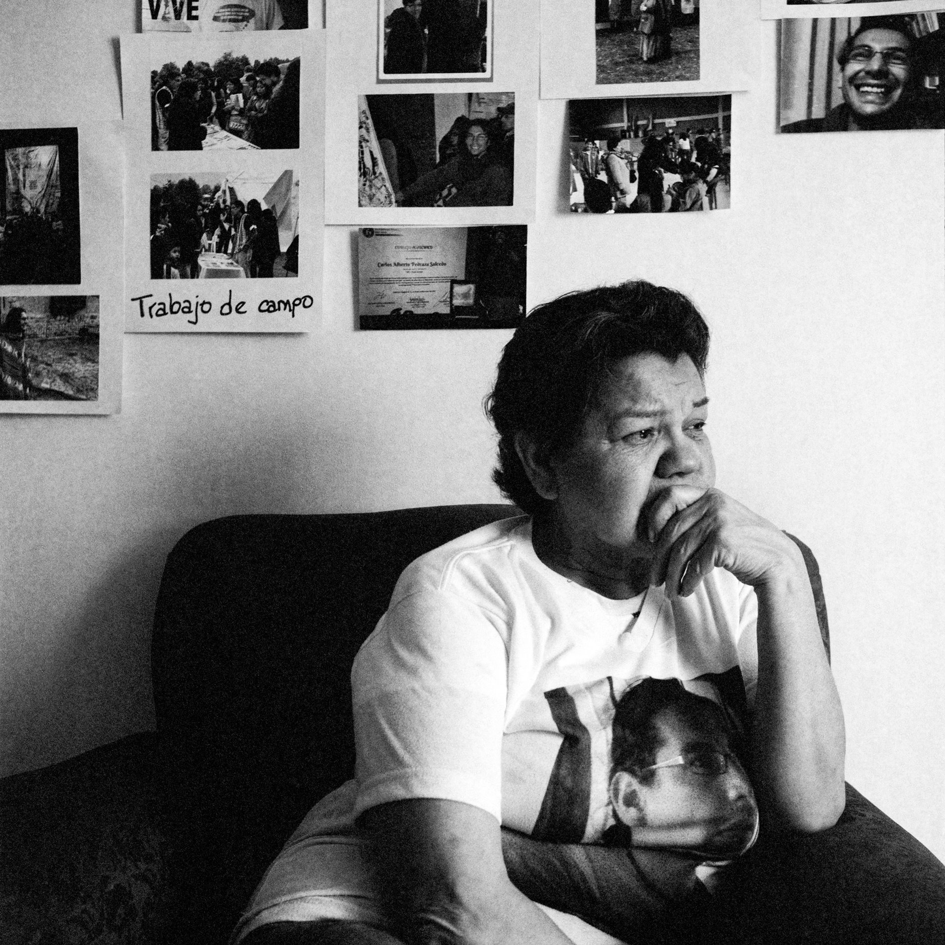 The mother of Carlos Alberto Pedraza Salcedo, who was disappeared in Bogotá on 19 January 2015, sits in the living room of her home in Bogotá, Colombia. She wears a T-shirt bearing his image, and has photographs of her son on the wall. Pedraza was found dead, with a gunshot wound to the head, in a nearby municipality two days after he disappeared. A student leader, he had been investigating &#39;false positives&#39; (extrajudicial executions committed by the Colombian security forces) on behalf of the National Movement of Victims of State Crimes (MOVICE).