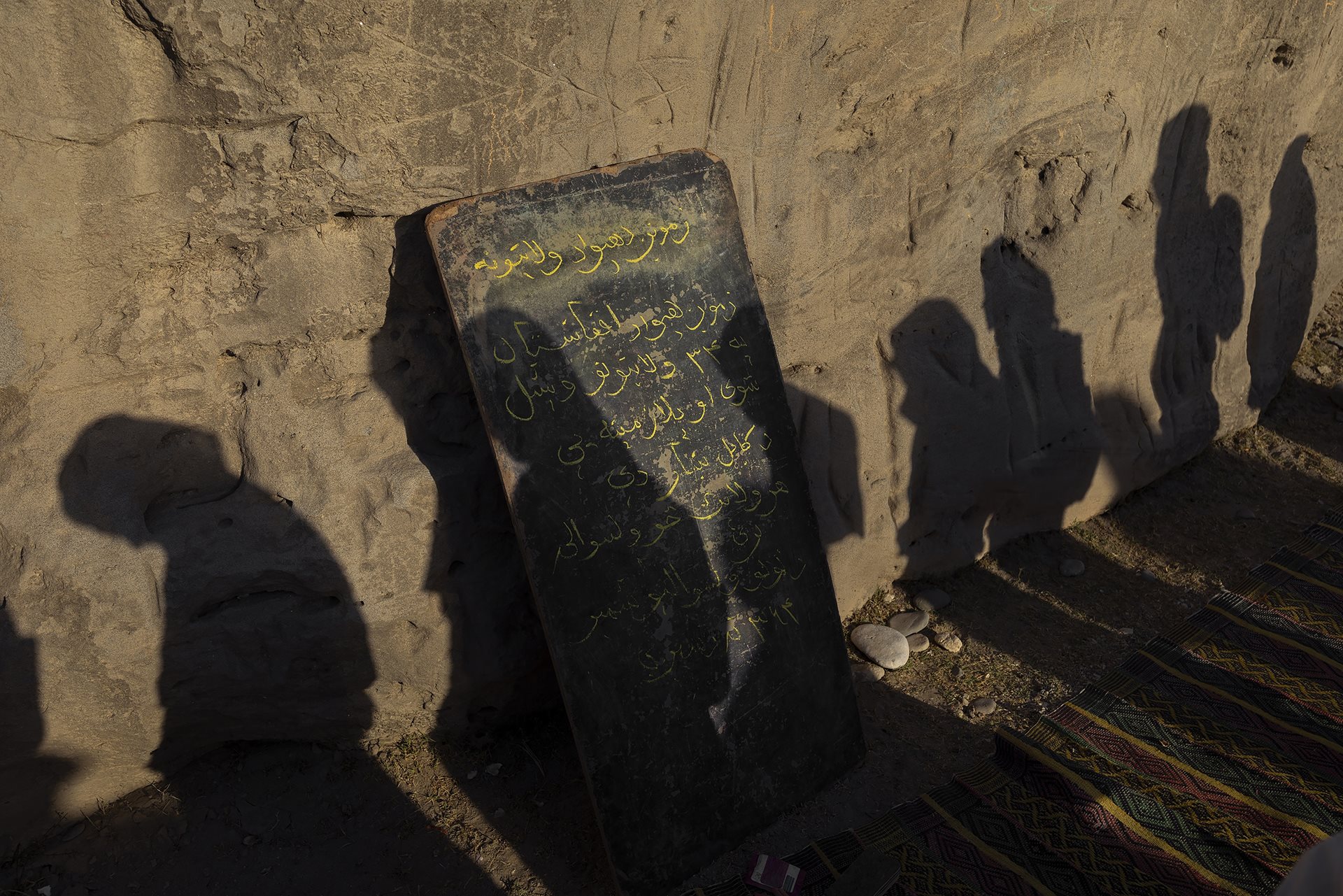 Girls attend an informal open-air school in Chaparhar District, Afghanistan. The ban on girls attending school continues to undermine the right to education, affecting nearly 2.2 million students.