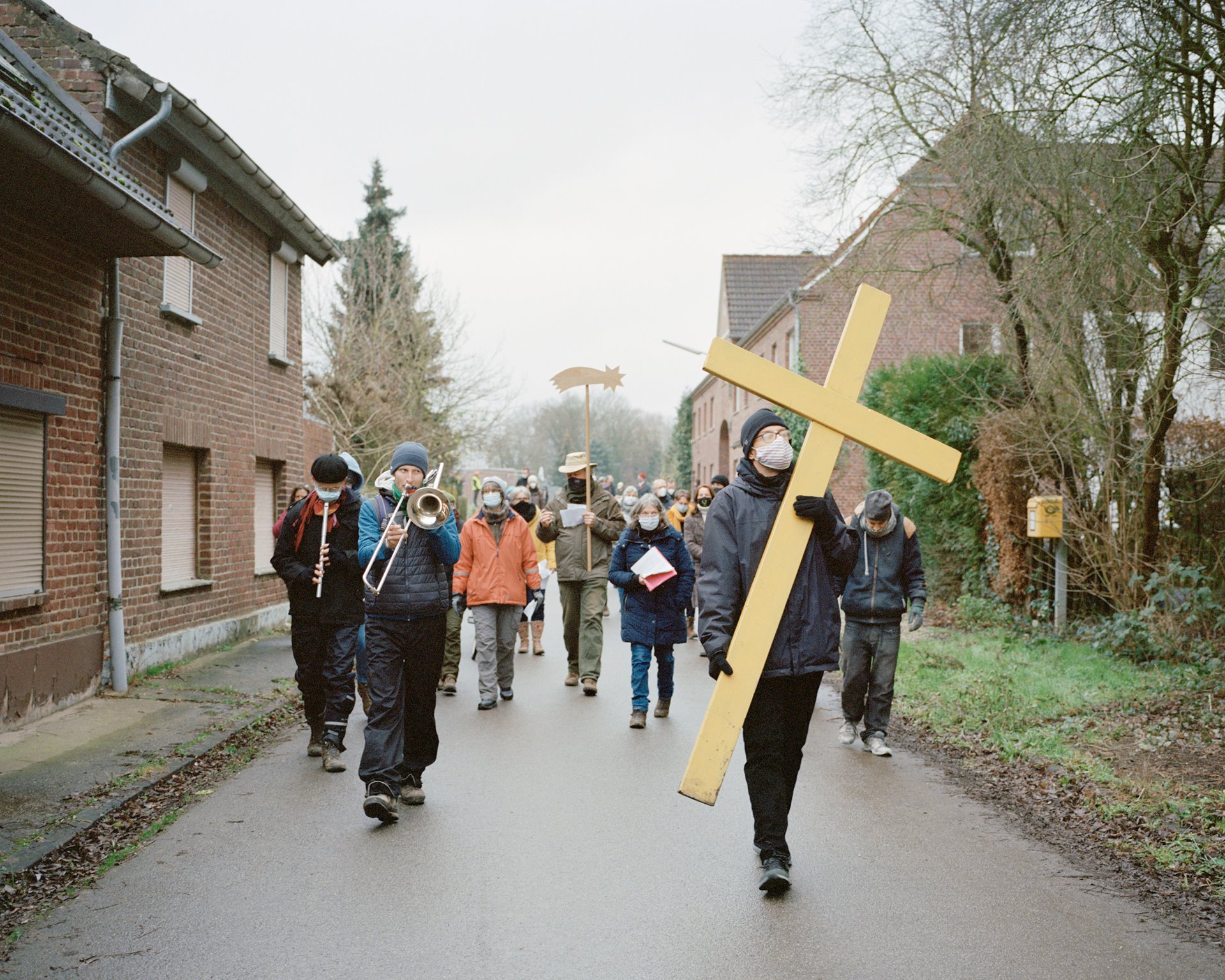 Activists process through Lützerath at Epiphany. Although five other villages were saved, the government allowed RWE energy company to demolish Lützerath in 2023, in return for bringing forward its coal phase-out from 2038 to 2030.