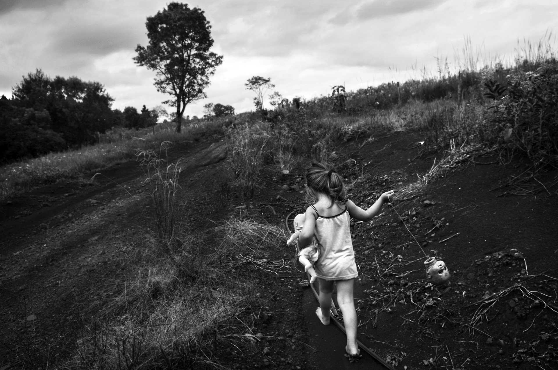 A girl runs through fields near the Brazilian border in Misiones, Argentina. Her siblings have disabilities and organ failure attributed to their father&rsquo;s 30-year career handling methyl bromide on tobacco plantations.