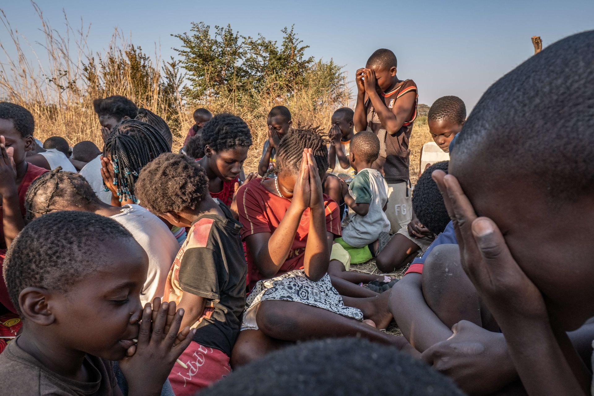 Children pray during a conservation education session on elephant safety, which is run daily by the Conservation and Tourism Society, a small non-profit that also operates the Elephant Response Team in Livingstone, Zambia. Children learn practical tips on how to stay safe around elephants, as well as broader conservation issues.