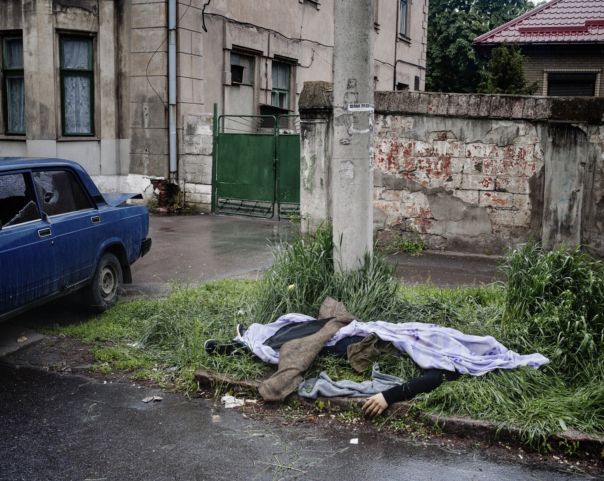 The body of a man lies in front of a police station, in Mariupol, Ukraine, following a fight between separatist militia and the Ukraine National Guard.
