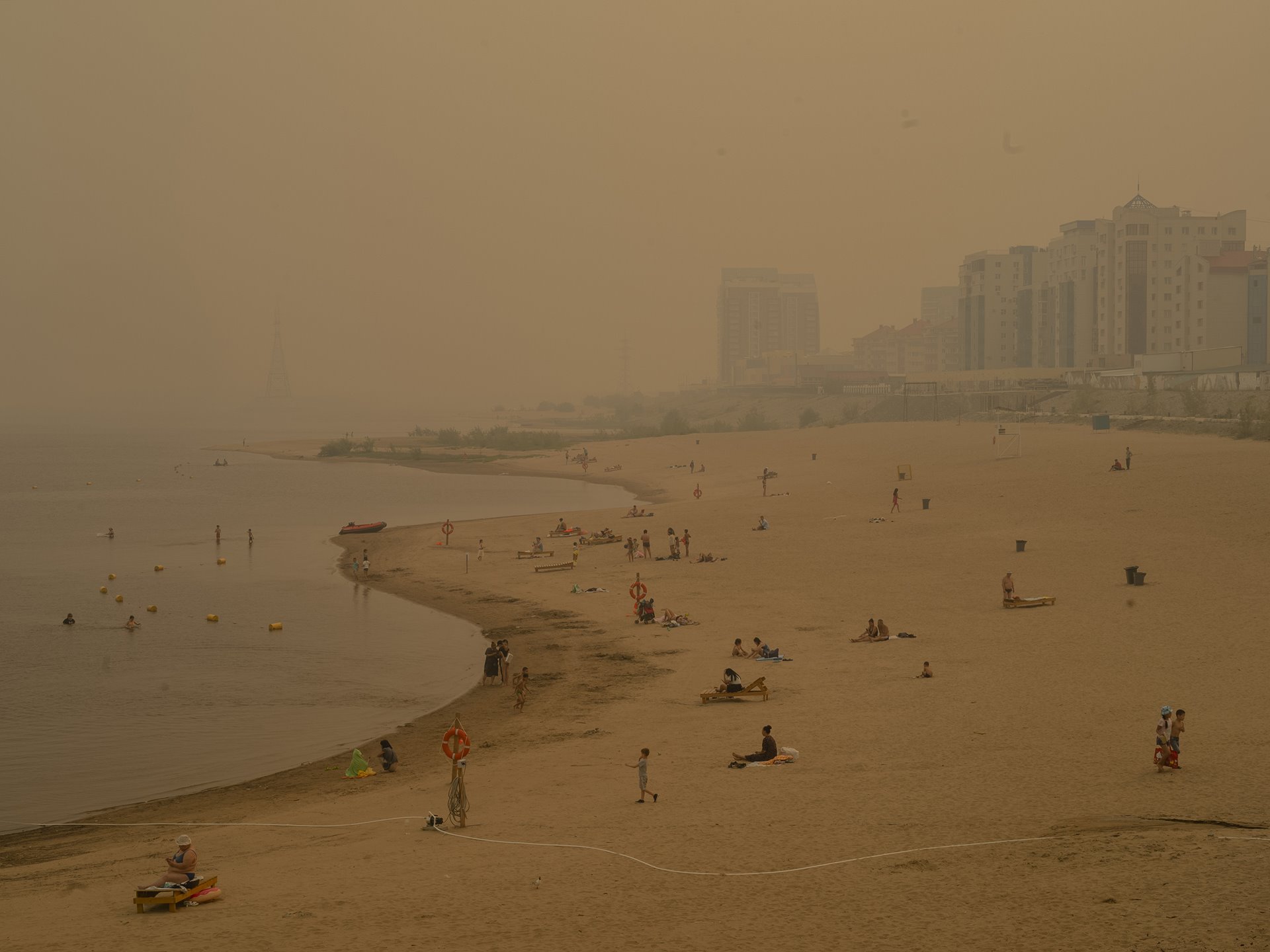 Despite a warning from local authorities for citizens to stay indoors to avoid choking fumes, some people in the capital Yakutsk passed time on the beach, Yakutsk, Sakha, Siberia, Russia.