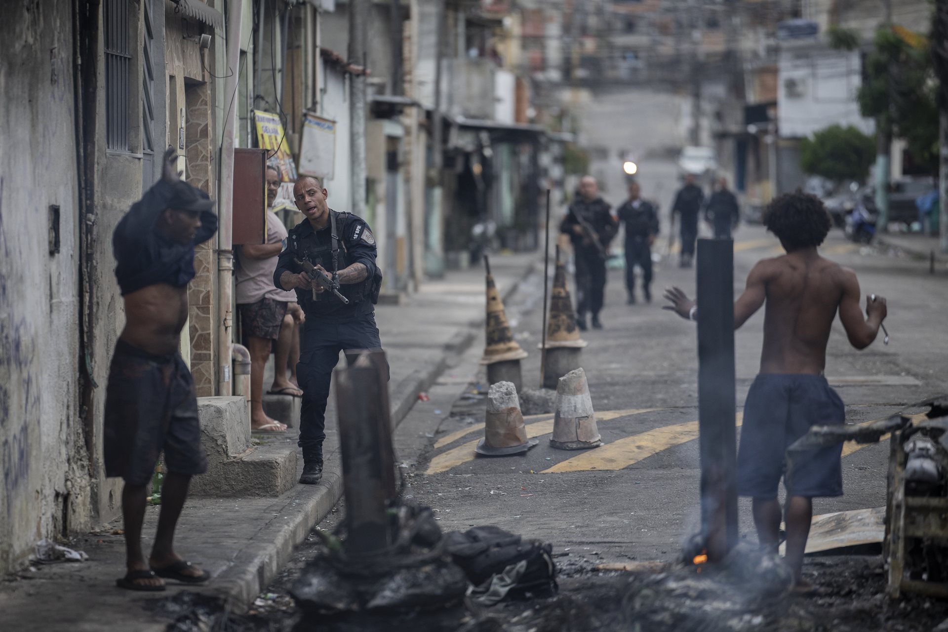 Police search suspects near the entrance to the Penha complex in Rio de Janeiro, Brazil. The massive deployment involved 2,500 officers. While the state justified the mission as a strike against organized crime, the operation failed to achieve its primary goal: the capture of any of its high-ranking targets.