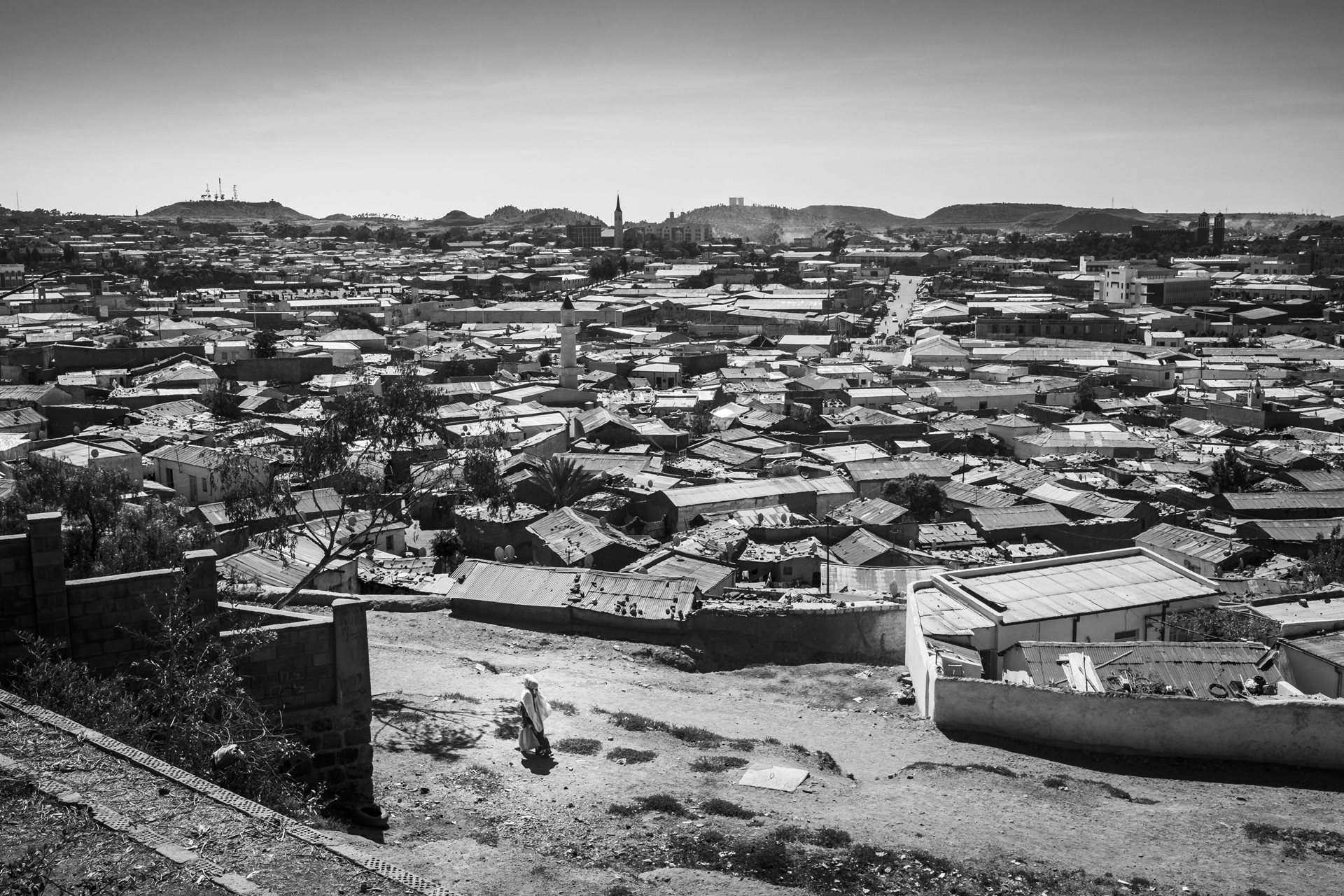 An Eritrean woman on the outskirts of Asmara, Eritrea. Beneath this peaceful surface lies a pervasive espionage network responsible for detaining, torturing, persecuting, raping, and disappearing citizens in the name of political control. The United Nations Commission of Inquiry on Human Rights denounced the Eritrean government&#39;s systematic repression.