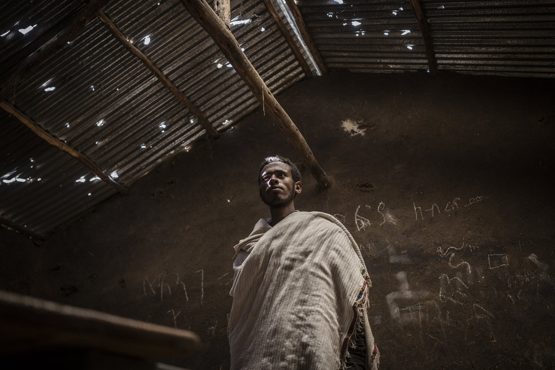 Hailemariam Girma looks at a damaged school, allegedly looted by pro-Tigray forces in Mesobit, Amhara, Ethiopia.