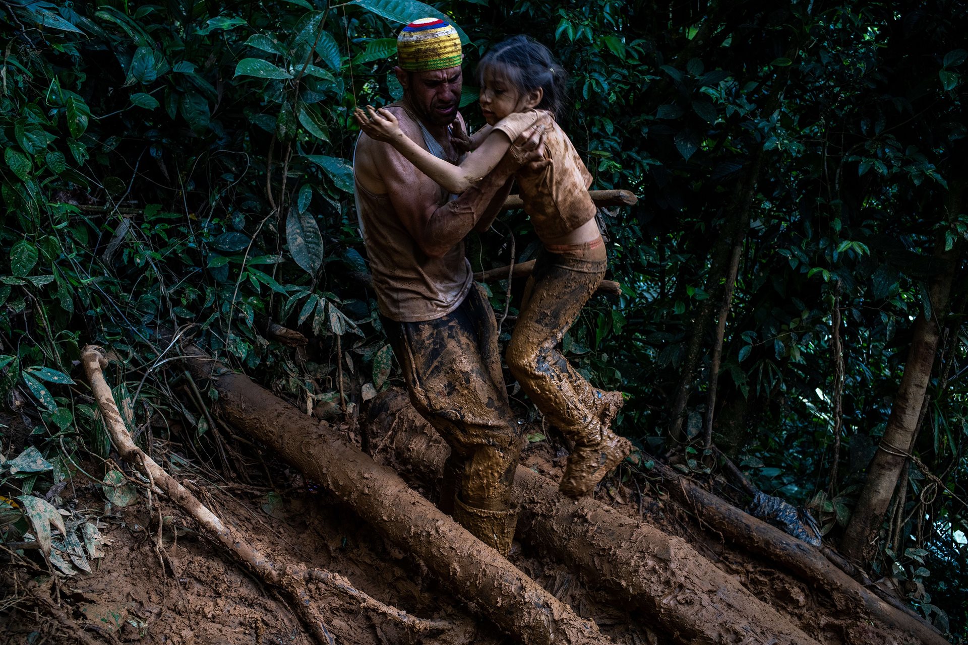 Sarah Cuauro, (6) was separated from her mother during their trek through the jungle. Ángel Garcia, (42) took care of her for several days as they climbed through the mud to Banderas Hill, a crossing point in the Darién Gap. They had no idea where Sarah&#39;s mother was or whether she was injured.