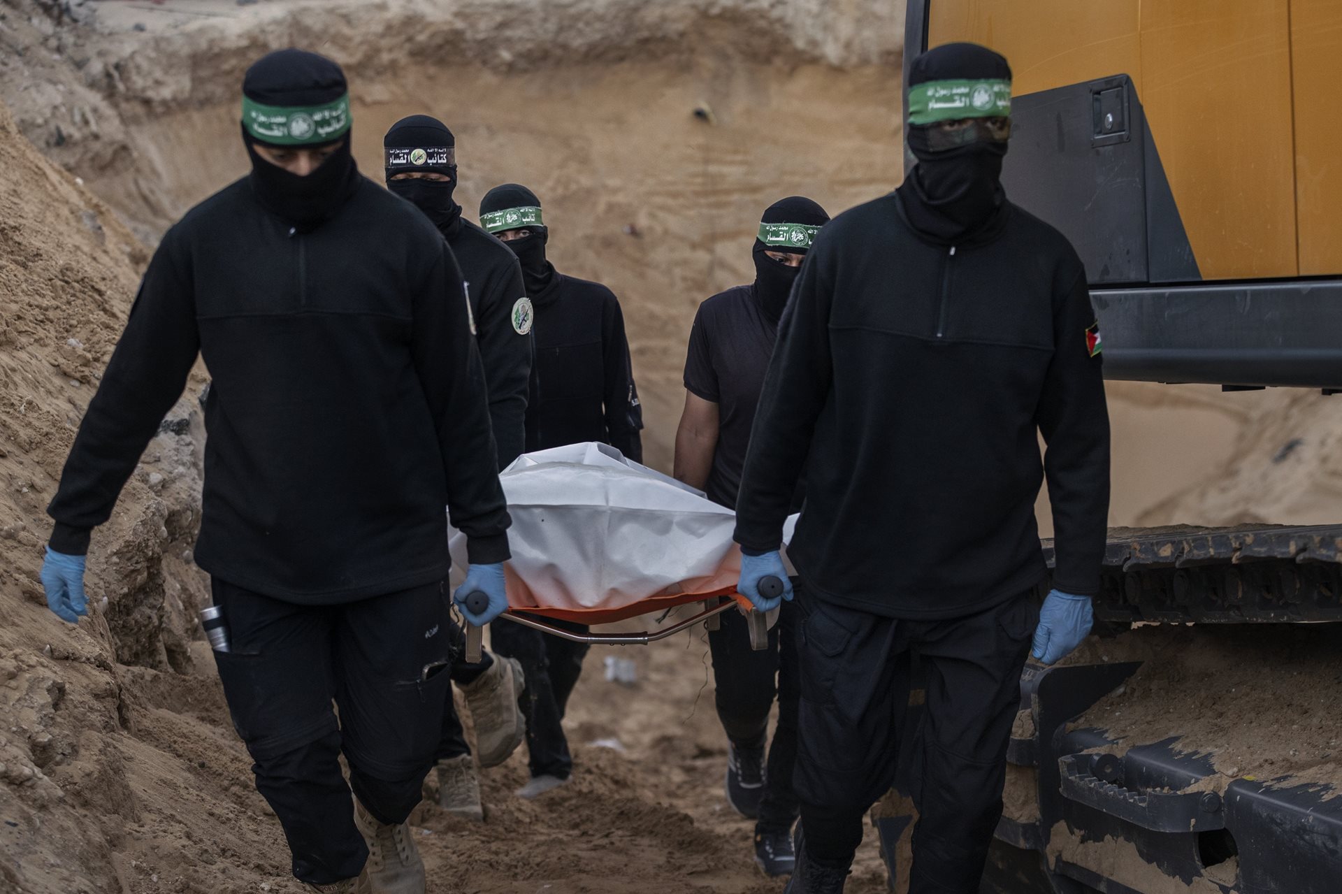 Members of Hamas carry what are believed to be the remains of an Israeli hostage in Khan Younis, Gaza Strip. Following the ceasefire agreement, Hamas returned all 20 living hostages and 28 bodies.