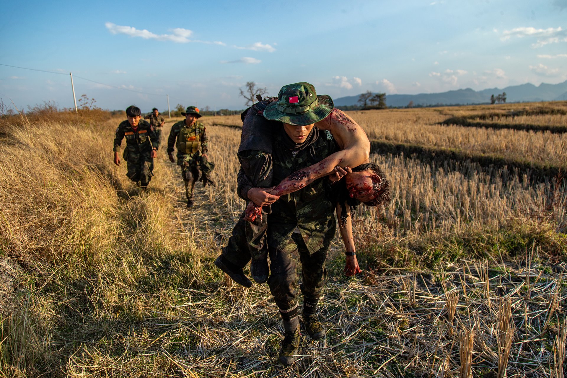 <p>Resistance fighters from the People&#39;s Defense Forces (PDF) retreat with the body of a comrade, following a clash with the Myanmar military, in Moe Bye, Kayah (Karenni) State, Myanmar.</p>
