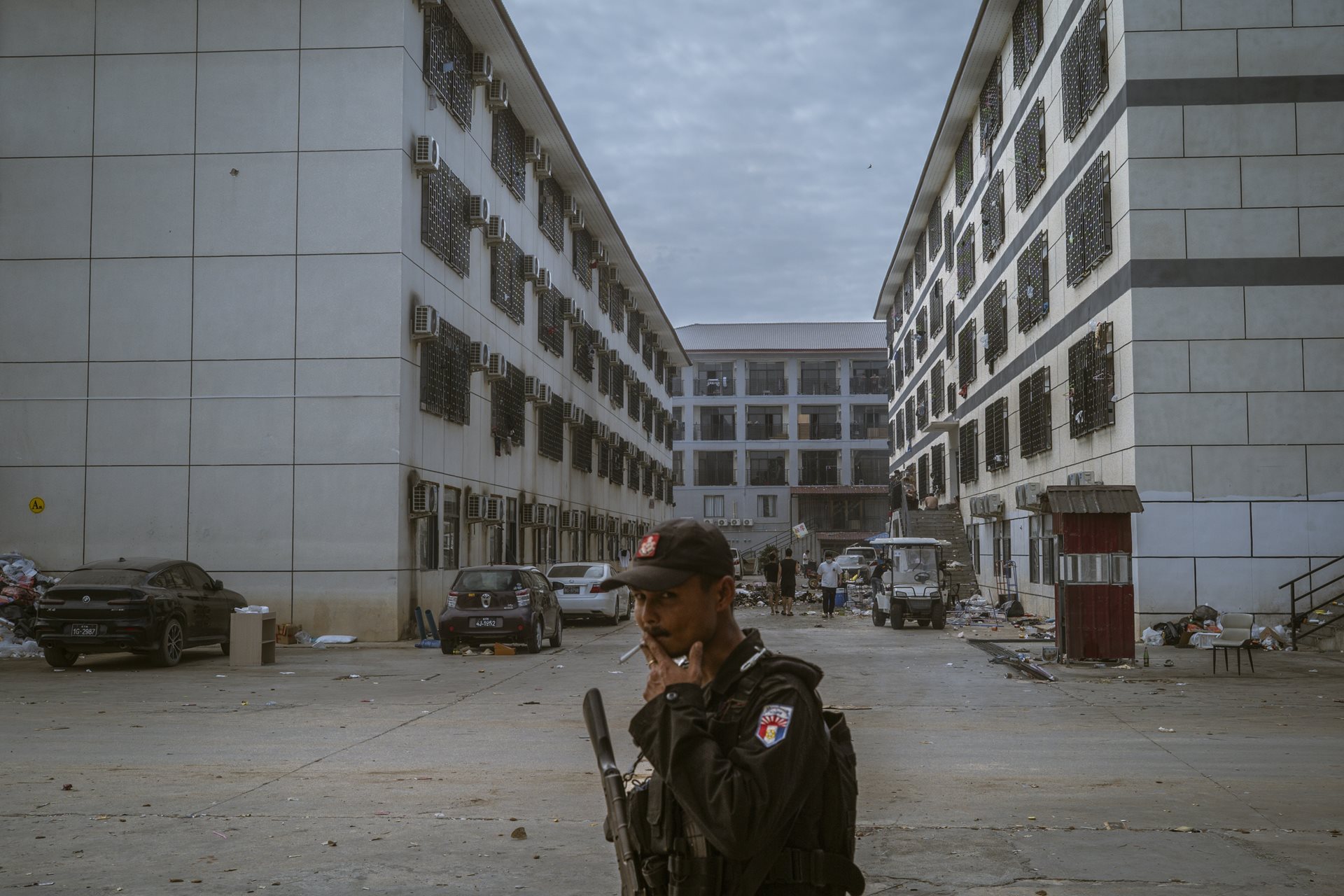 A Karen National Liberation Army soldier patrols the Shunda Park compound in Min Let Pan, Myanmar. Approximately 900 Chinese employees remained barricaded here for weeks after the raid, fearing that repatriation could lead to immediate arrest by Chinese authorities.