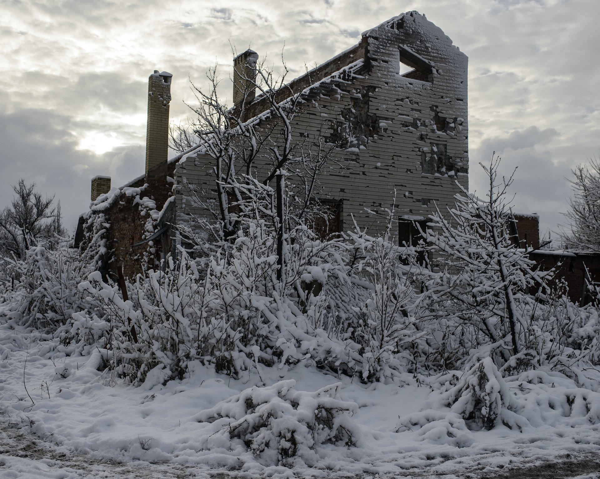 A ruined house stands on a street in Pisky, Donbas, Ukraine, on the front line of the conflict between Ukraine government forces and separatists from the self-proclaimed Donetsk People&#39;s Republic (DNR). Pisky was formerly a wealthy suburb of Donetsk. By 2016, only a handful of its more than 2,000 pre-war residents remained.