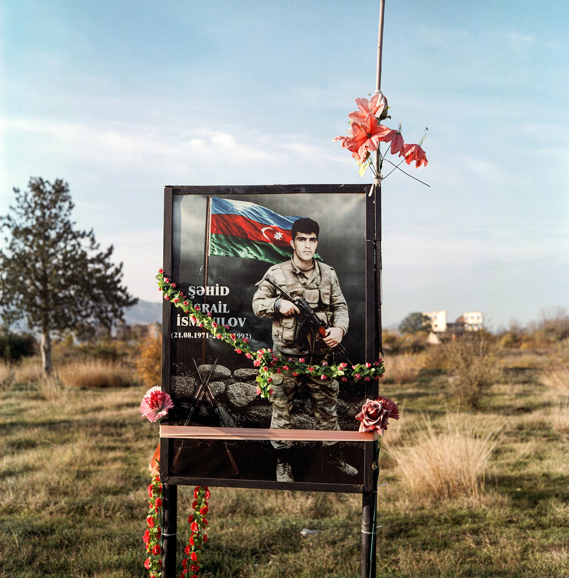 Flowers are placed on the graves of those who perished fighting in the First Nagorno-Karabakh War by family members who have returned to the province of Agdam, Azerbaijan.