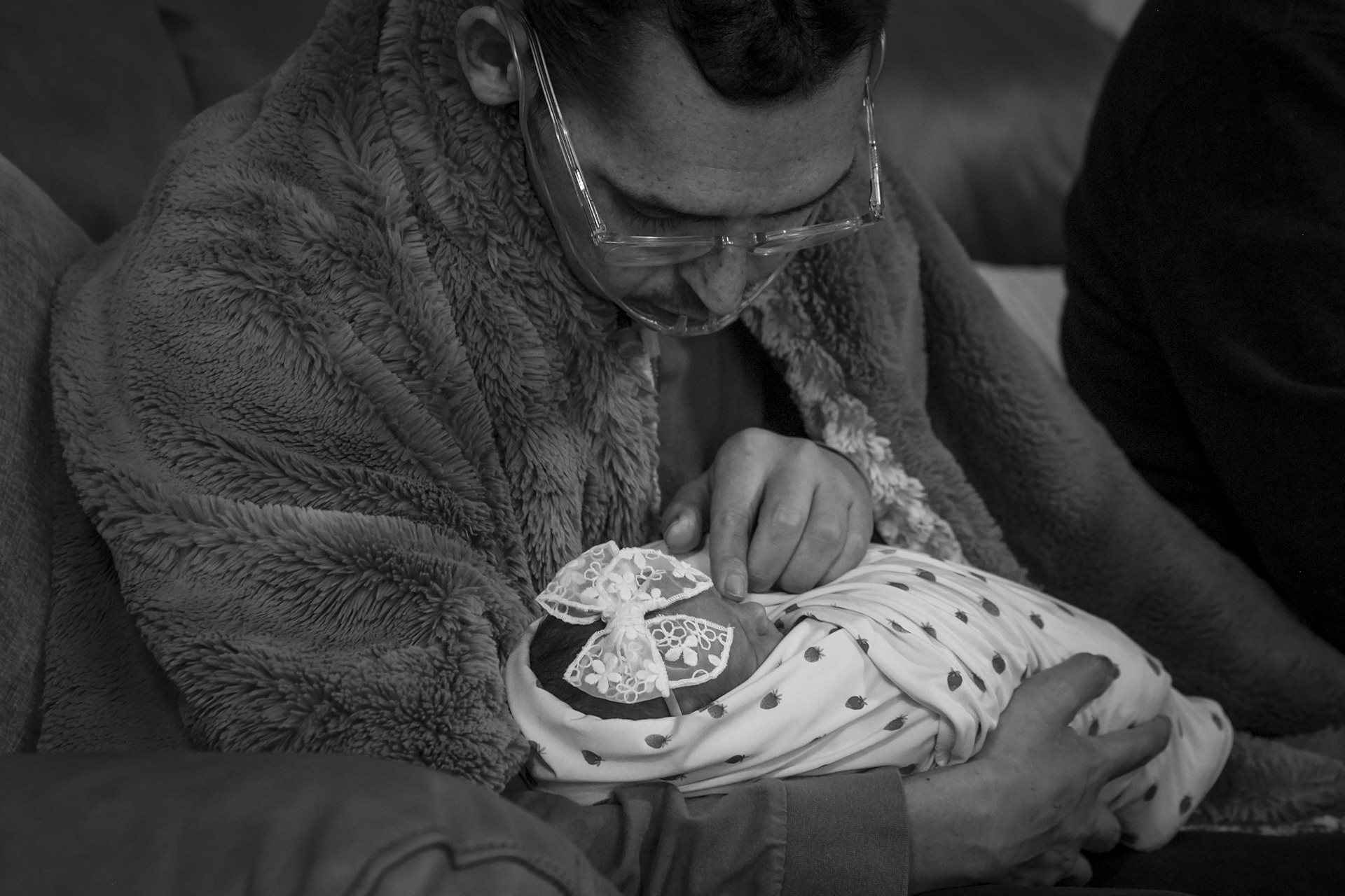 <p>Tanner cradles AmyLou two days after her birth. Too weak to stand, Tanner held his daughter on his lap while Shay filmed a father-daughter dance for their daughter&rsquo;s future wedding. American Fork, Utah, United States<br />
<br />
&nbsp;</p>
