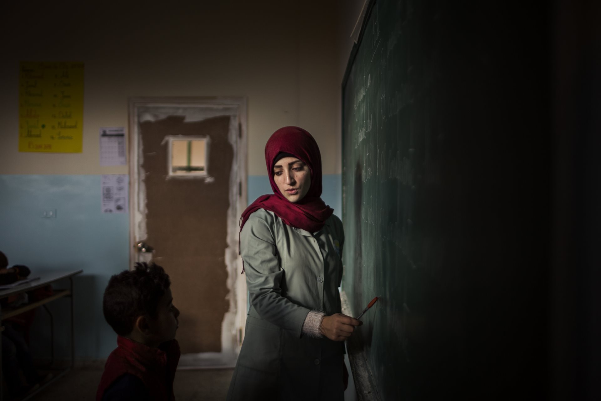 A young Syrian refugee attends a class on the outskirts of Arsal,&nbsp;Lebanon. Limited resources, residency issues, and work restrictions on parents deny many refugee children access to education.