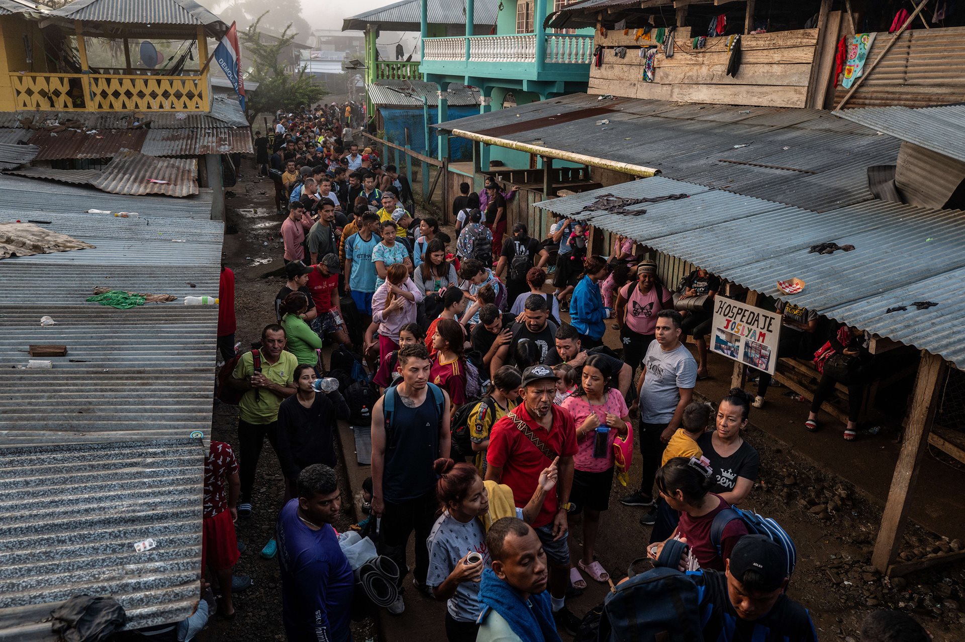 Hundreds of migrants stand in line to board small wooden boats that will take them from Bajo Chiquito to the Migrant Reception Station in Lajas Blancas. Each migrant is required to pay $20 USD to the indigenous community for their spot on the boat. Darién Gap, Panama.<br />
&nbsp;
