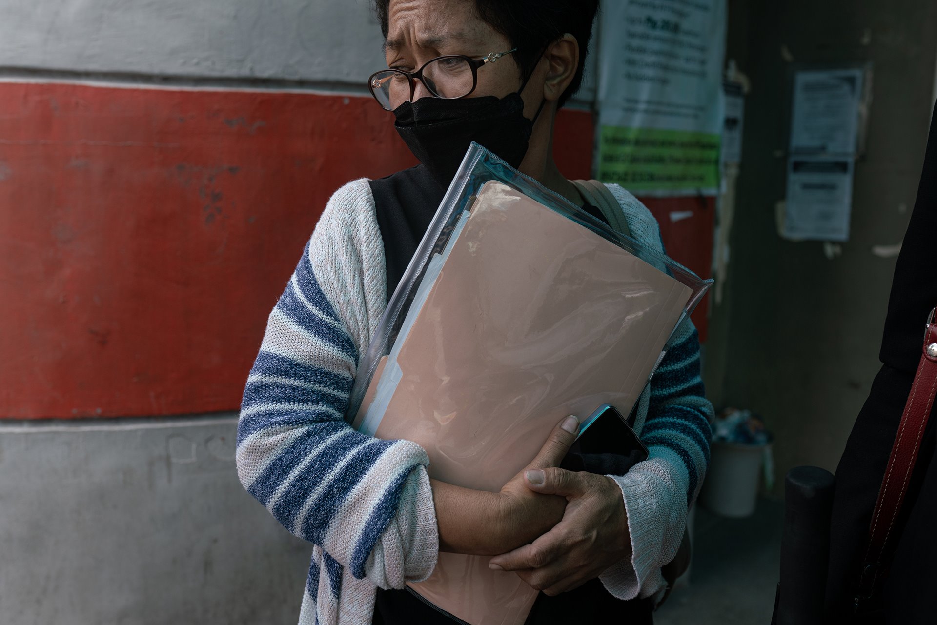 <p>Mary Anne Domingo stands outside a courthouse after giving testimony, in Caloocan, the Philippines. She brought a case against the police after her husband and son were killed in a raid in 2016. The trial commenced in 2021.</p>
