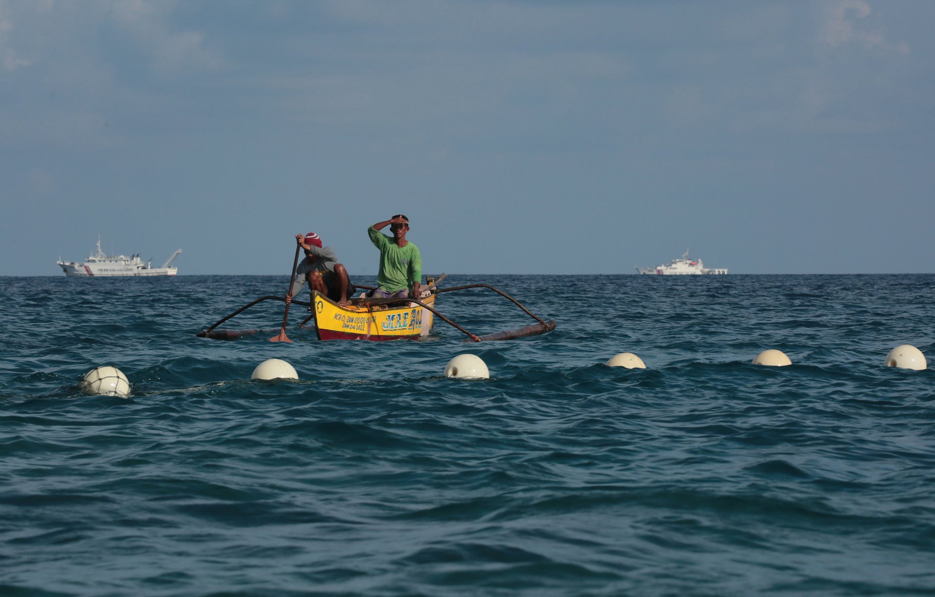 Filipino fishermen outside a floating barrier installed by the China Coast Guard near the entrance to Scarborough Shoal. According to the Philippine Coast Guard, three rigid-hull inflatable boats from the China Coast Guard and a Chinese maritime militia service boat installed the 300-meter-long barrier, which the Philippine Coast Guard removed with the help of a Filipino diver with a knife on 25 September 2023.<br />
&nbsp;