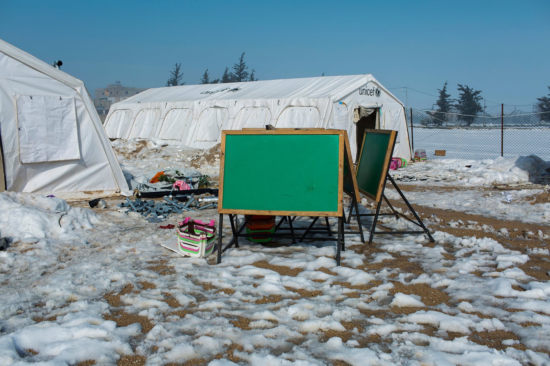 A chalkboard surrounded by snow outside a school for Syrian refugees in Zahle, Lebanon. Freezing temperatures and lack of secure shelter pose serious health risks for refugees across the region.