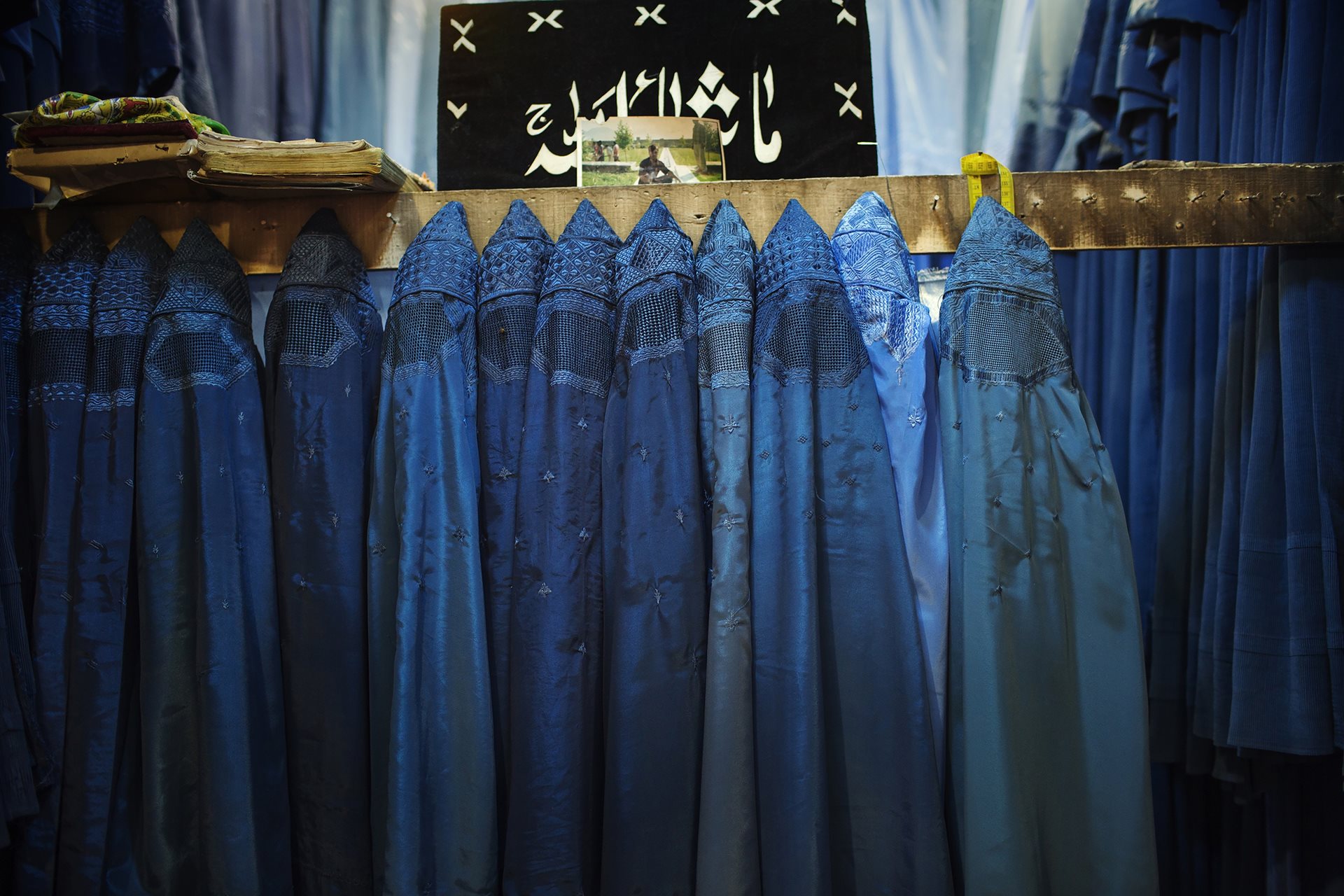 A row of burqas hangs in a vendor&rsquo;s shop in a country where the Taliban has banned girls from secondary and higher education. Kabul, Afghanistan.