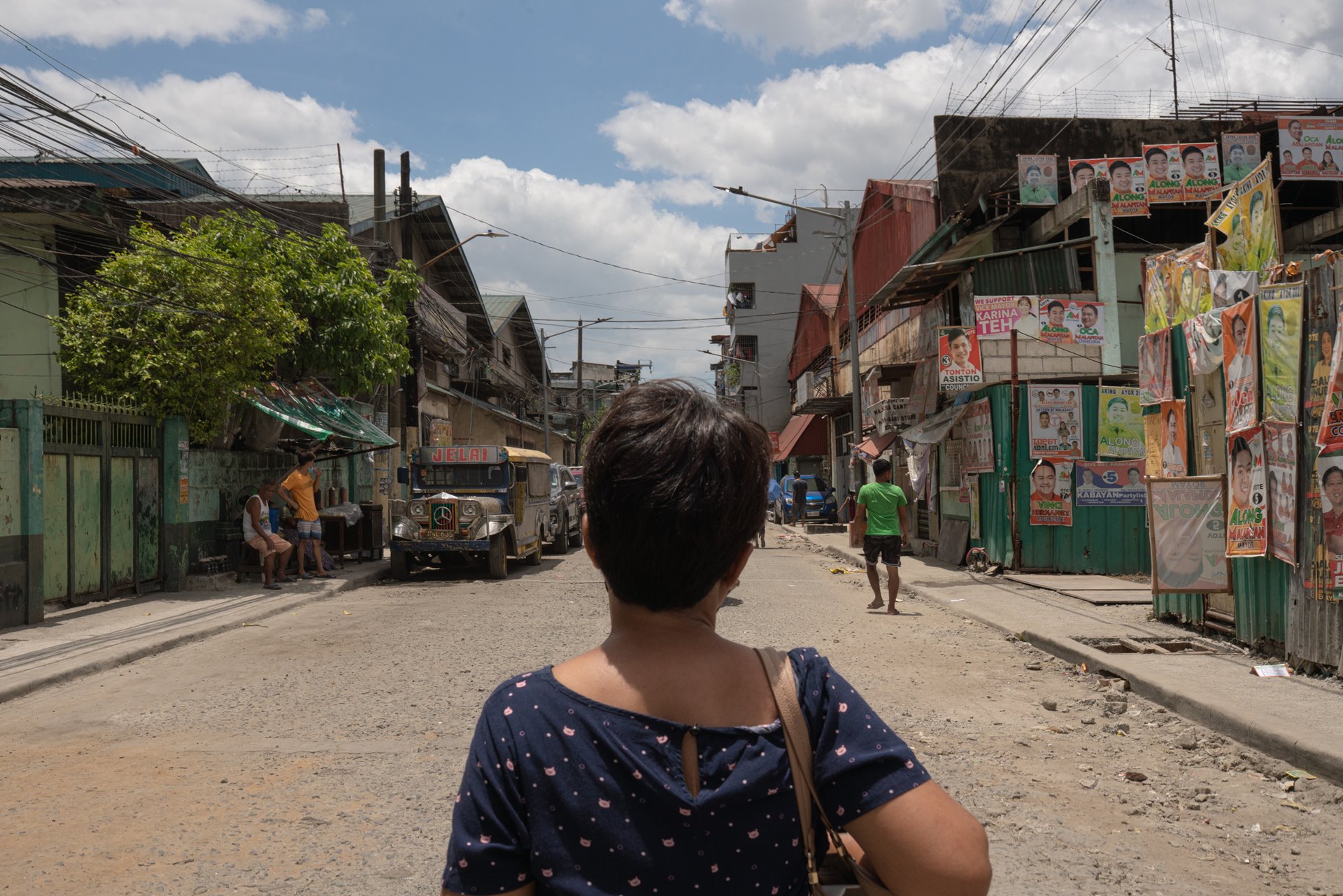 Mary Anne Domingo sets out to cast her vote in Caloocan, the Philippines. She brought a case against the police after her husband and son were killed in a raid in 2016. The trial commenced in 2021.