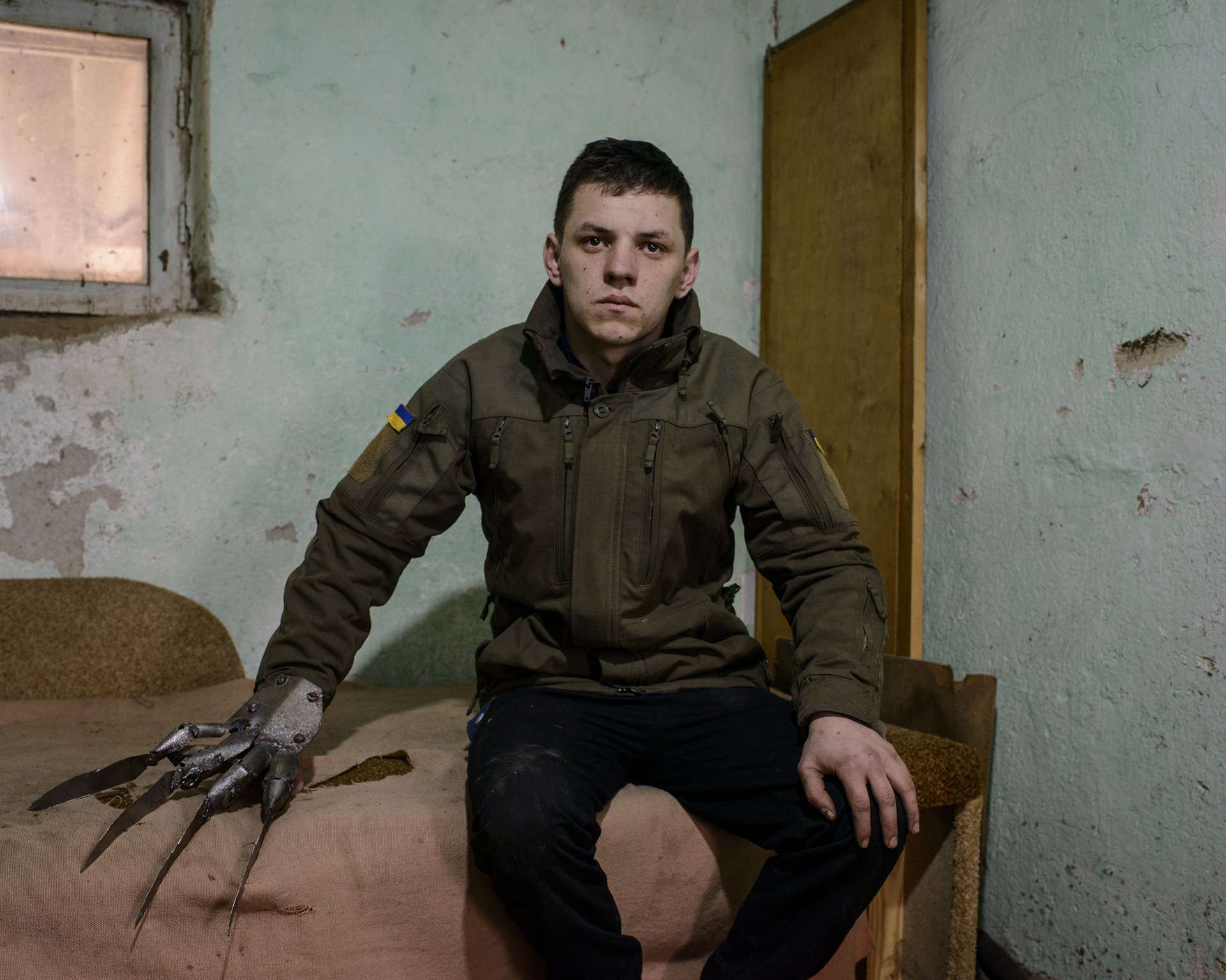 Alexander Yanushkevich wears a metal glove he made as an art object after returning from the front in the conflict between Ukrainian and separatist forces in the Donbas region in eastern Ukraine. Yanushkevich enlisted in the Ukrainian army as a cook in September 2017, and was sent to the front for five months. Since returning, and without work, he has been making metal art objects. The glove was the first one he made.