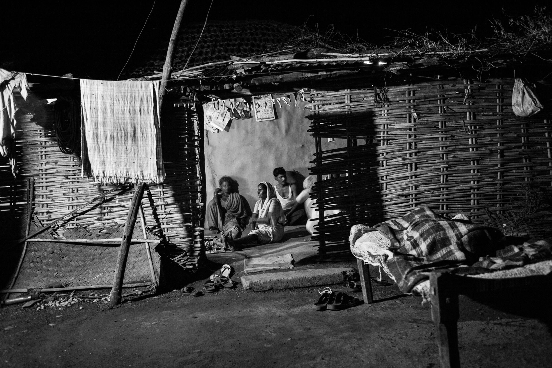 A family is portrayed in their home in the village of Navegaon, which is inside the core zone of the Tadoba Andhari Tiger Reserve, in Maharashtra, India.