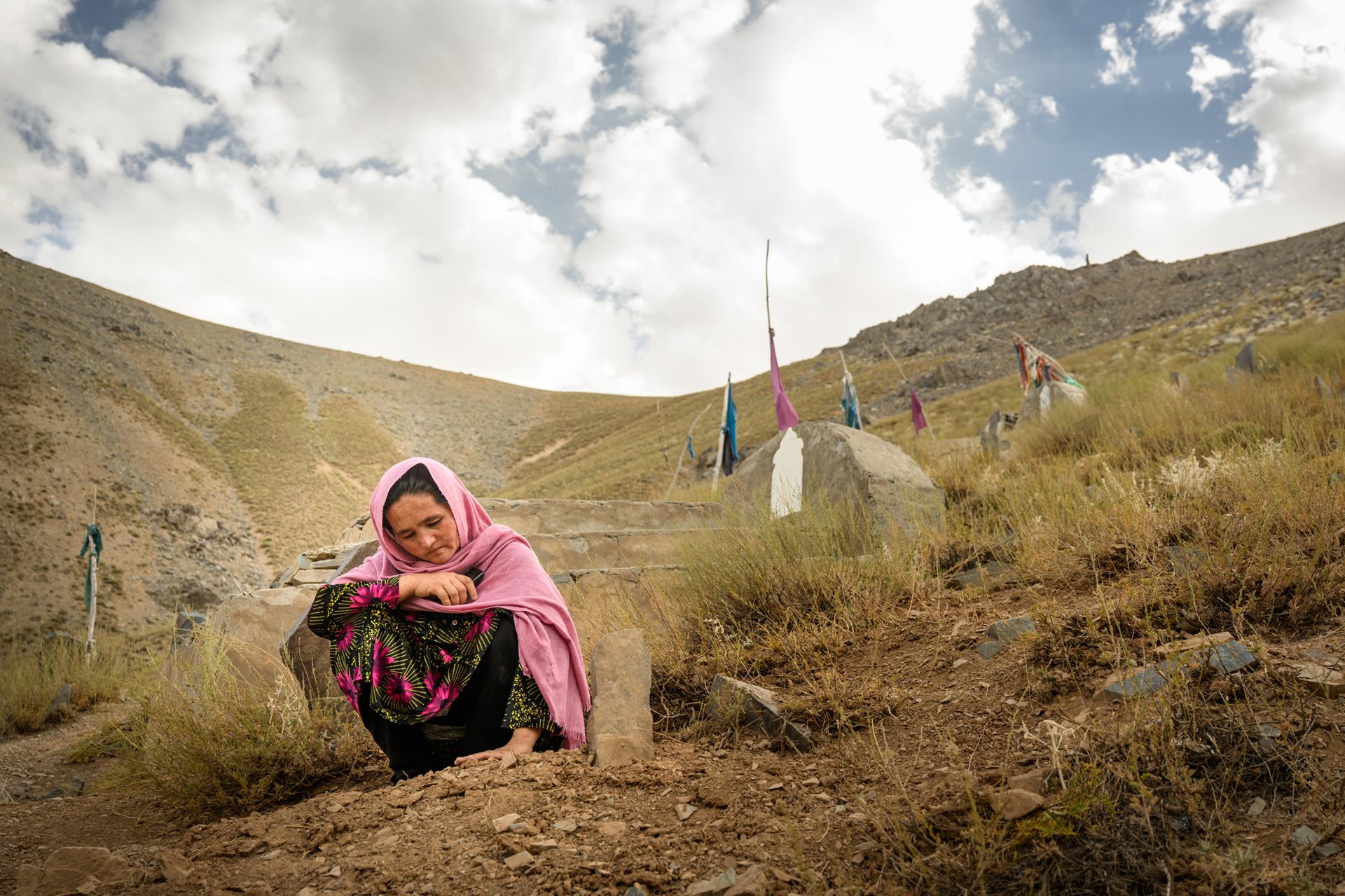 Mahwash visits the grave of her stillborn child for the first time, weeks after waiting two hours outside the closed Malmastok clinic before reaching another facility. Shahristan district,&nbsp;Daikundi province, Afghanistan.