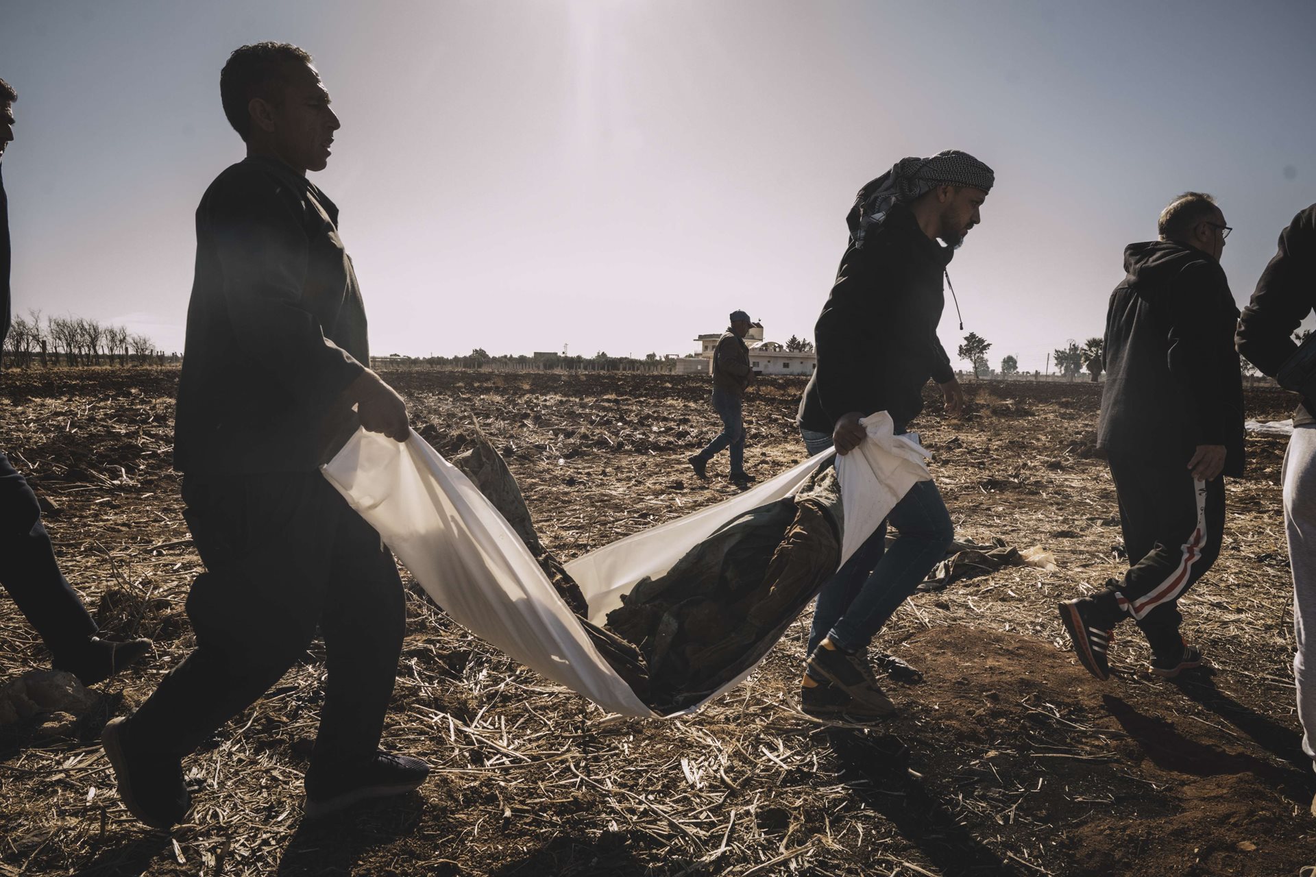 People exhume a mass grave containing dozens of bodies in Izra, Daraa, southern Syria. A growing tally of mass graves were discovered across the country after the fall of the Assad government. With the lifting of censorship, what had previously been rumor about grave locations became more publicized, and people began to search for their missing loved ones.&nbsp;