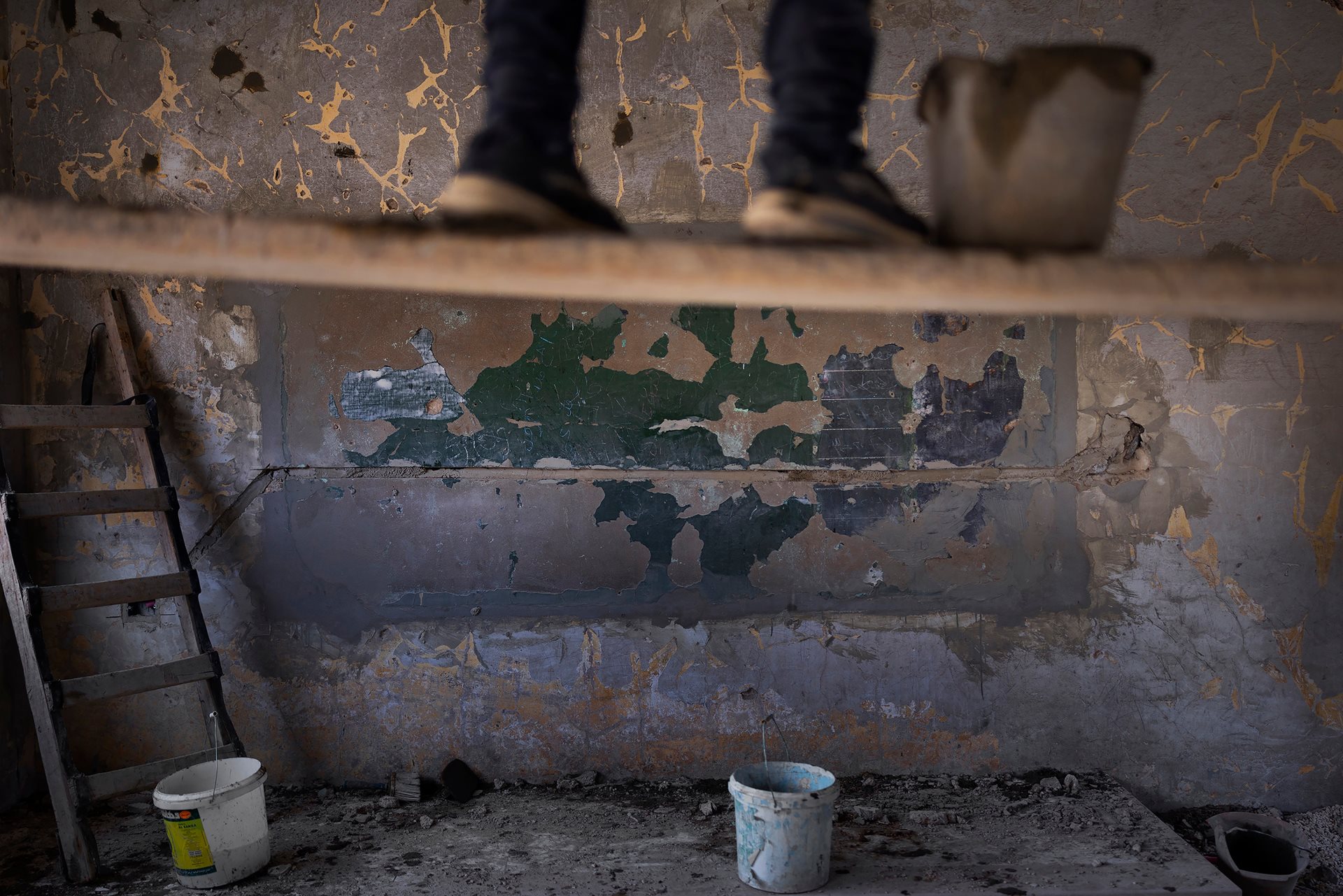 A worker rebuilds a destroyed school in Homs, Syria. Conflict has damaged or destroyed more than 7,000 schools across Syria, leaving around 2 million children out of school.
