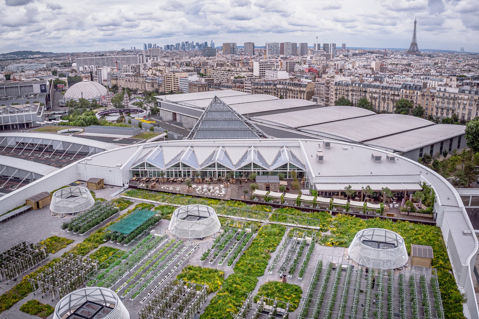 An aerial view of a rooftop farm that supplies local residents, neighboring hotels and restaurants with zero food-miles sustainable produce, in Paris, France. Occupying 14,000 square meters of space (about the size of two football pitches) the farm is home to more than 20 market gardens providing over 900 kilograms of fruit and vegetables a day in season, from about 30 different varieties of plant.&nbsp;
