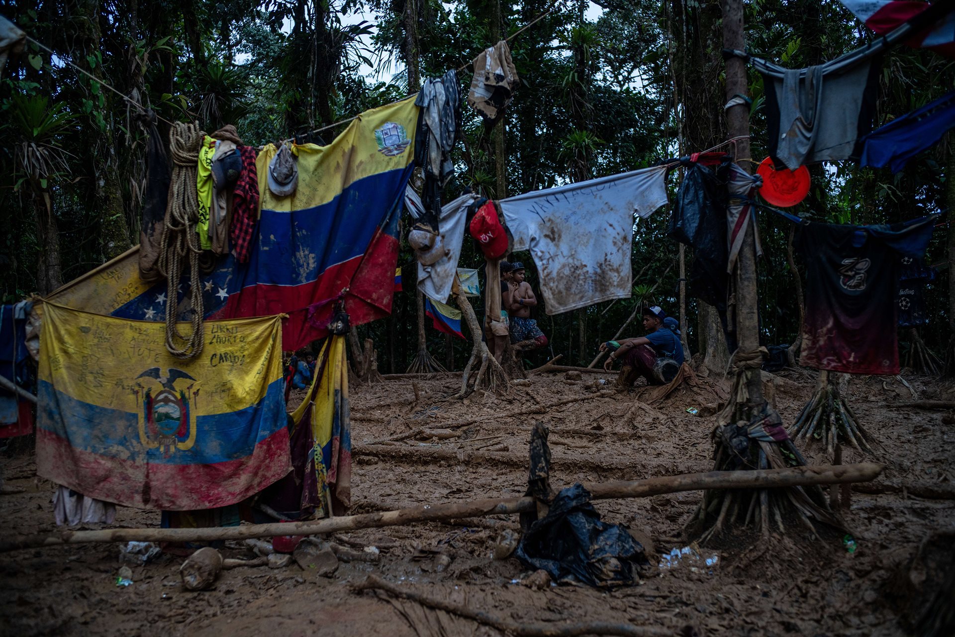 Flags from South American countries at the top of the &ldquo;Hill of Death.&rdquo; Government oversight is largely absent from the Darién region, which is primarily controlled by a criminal organization known as the Clan del Golfo. Members of this group treat migrants similarly to how they treat contraband like drugs: as commodities to be taxed and manipulated for profit.