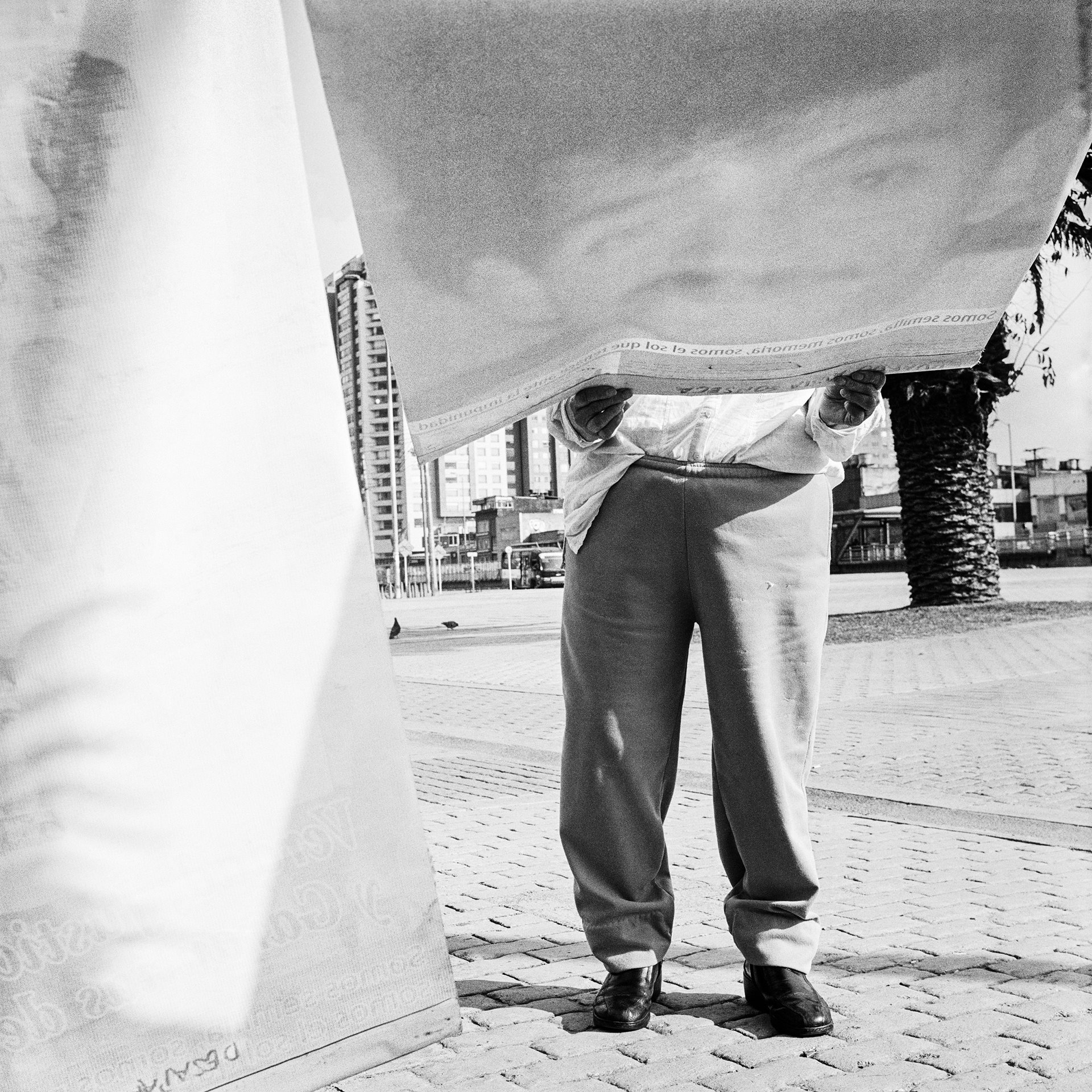 A passer-by looks at the photograph of a missing person during a protest against forced disappearance, in Bogotá, Colombia. The protest was organized by the National Movement of Victims of State Crimes (MOVICE) on the International Day of Enforced Disappearances, which is commemorated every year on 30 August.