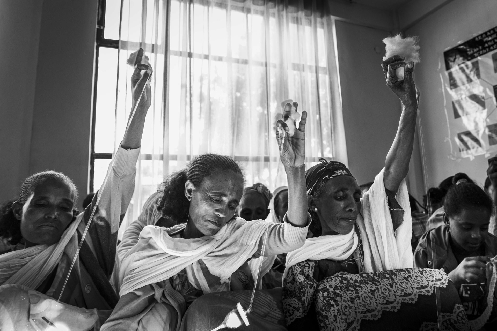 Tigrayan women weave decorations for traditional clothes at the Adi Shum Duhun Health Center in Mekelle, Tigray, Ethiopia. The group also welcomes women who suffered sexual violence during the war, providing emotional and material support. Trauma has a high human cost, and populations affected by sexual violence have an increased risk of PTSD. The resilience nurtured among these women creates strong bonds of solidarity and new forms of collective and transgenerational support.